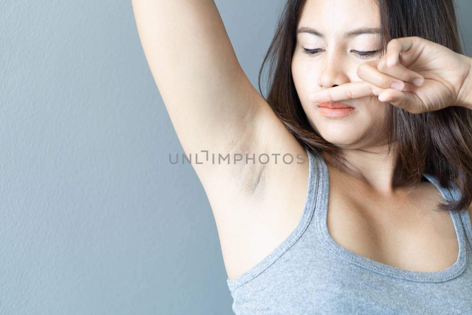 Women problem black armpit with grey background for skin care and beauty concept, selective focus