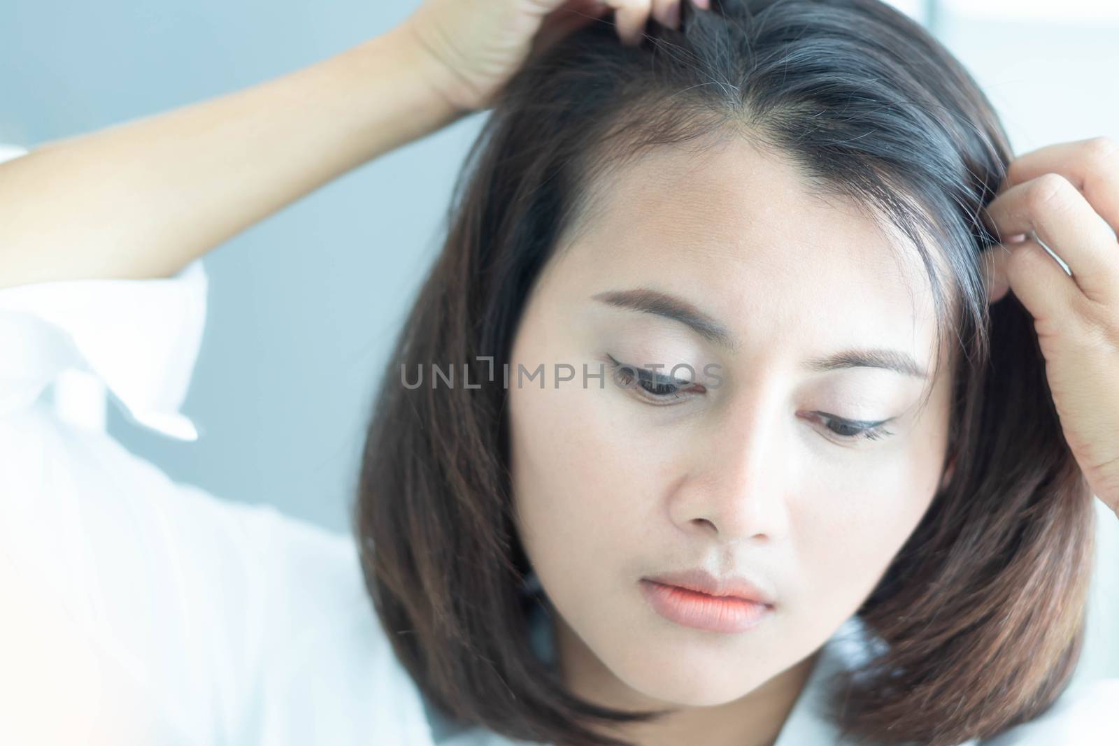 Woman looking reflection in the mirror serious hair loss problem by pt.pongsak@gmail.com