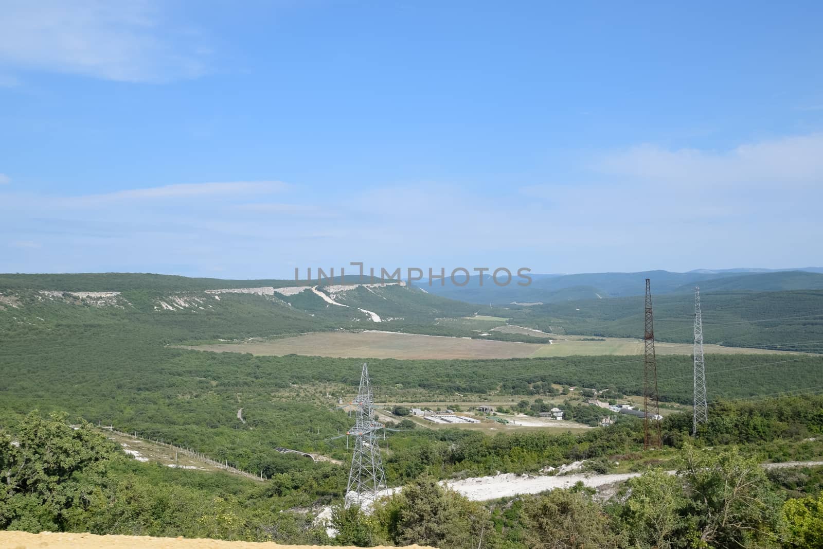 Landscapes of Crimean nature. Fields and hills visible from car window from the road.