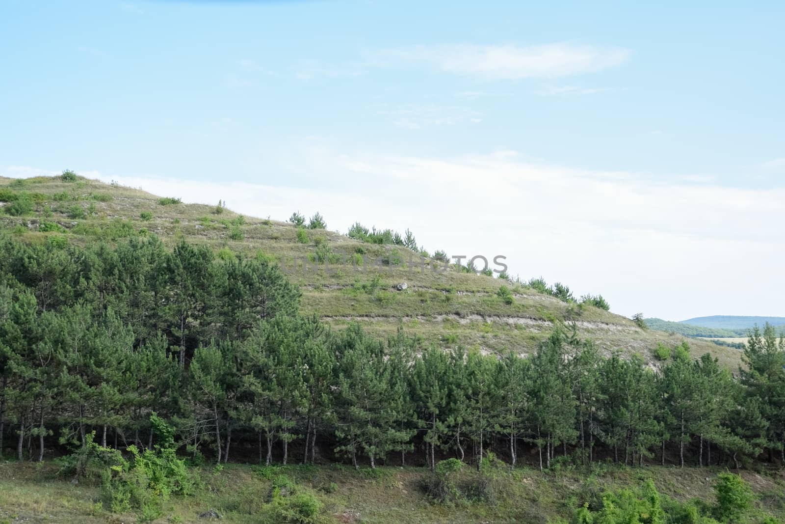 Landscapes of Crimean nature. Fields and hills visible from car window from the road.