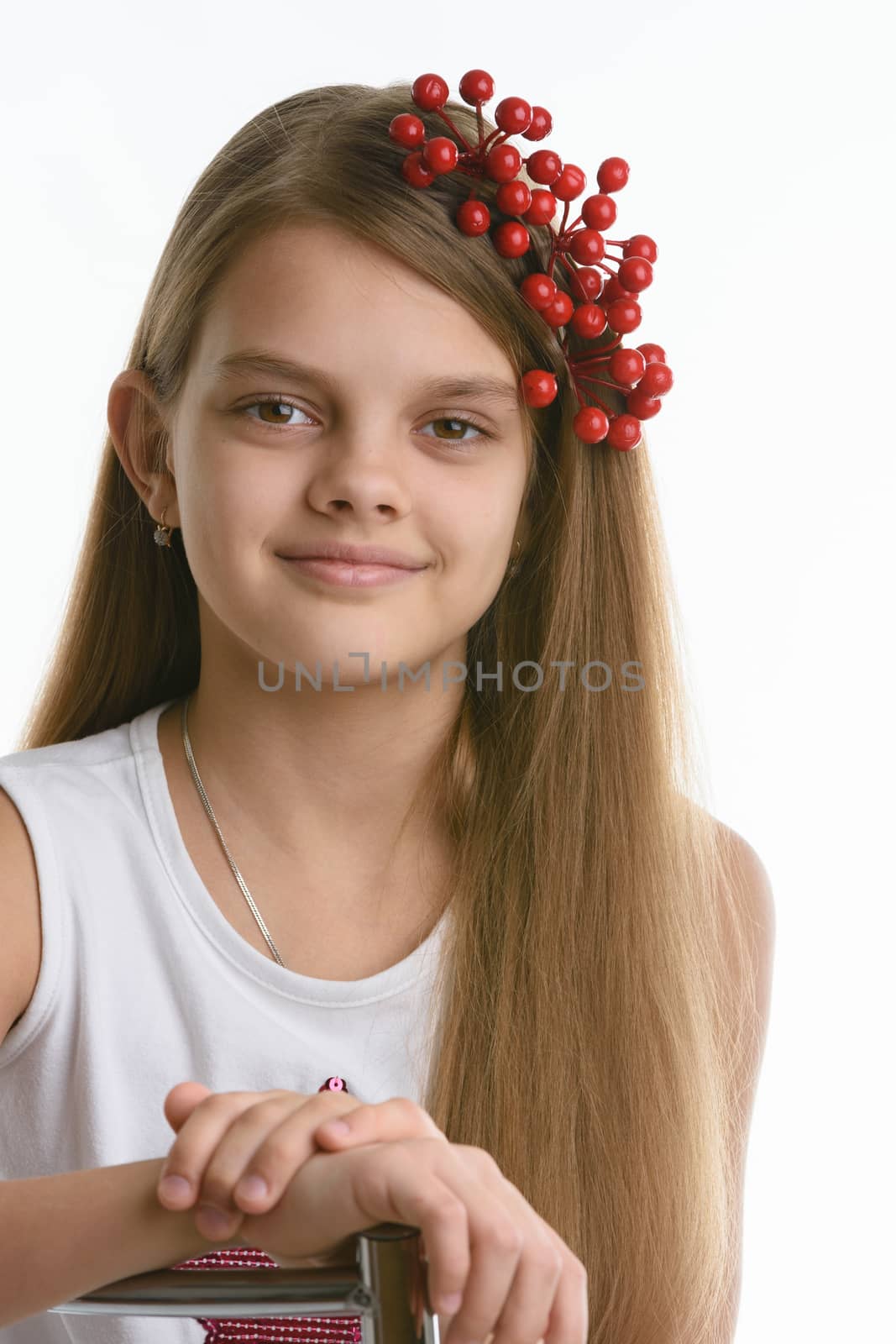 Portrait of a girl of Slavic appearance with a bunch of berries in her hair close-up