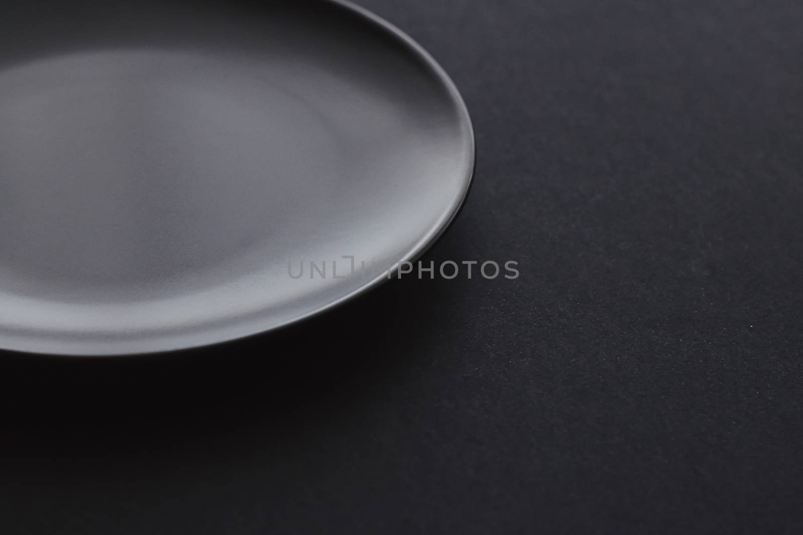 Empty plates on black background, premium dishware for holiday dinner, minimalistic design and diet concept