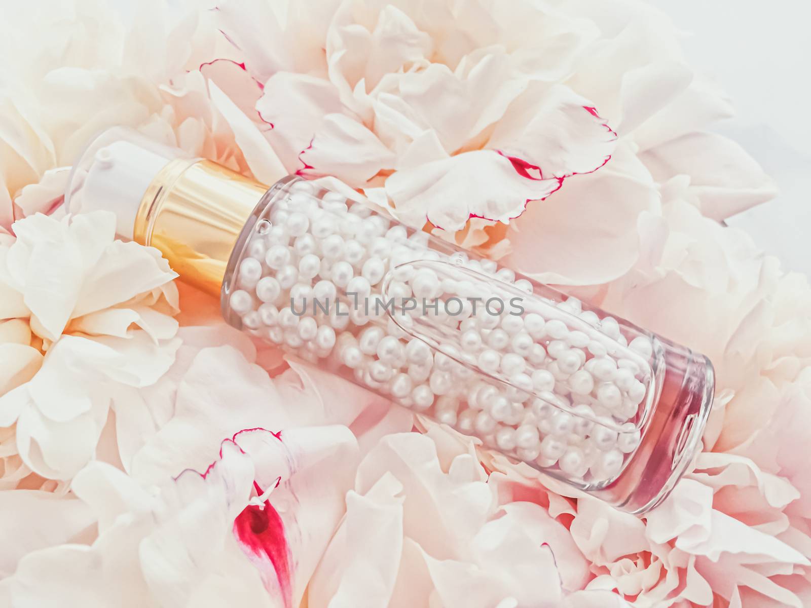 Luxurious cosmetic bottle as antiaging skincare product on background of flowers, blank label packaging for body care branding design