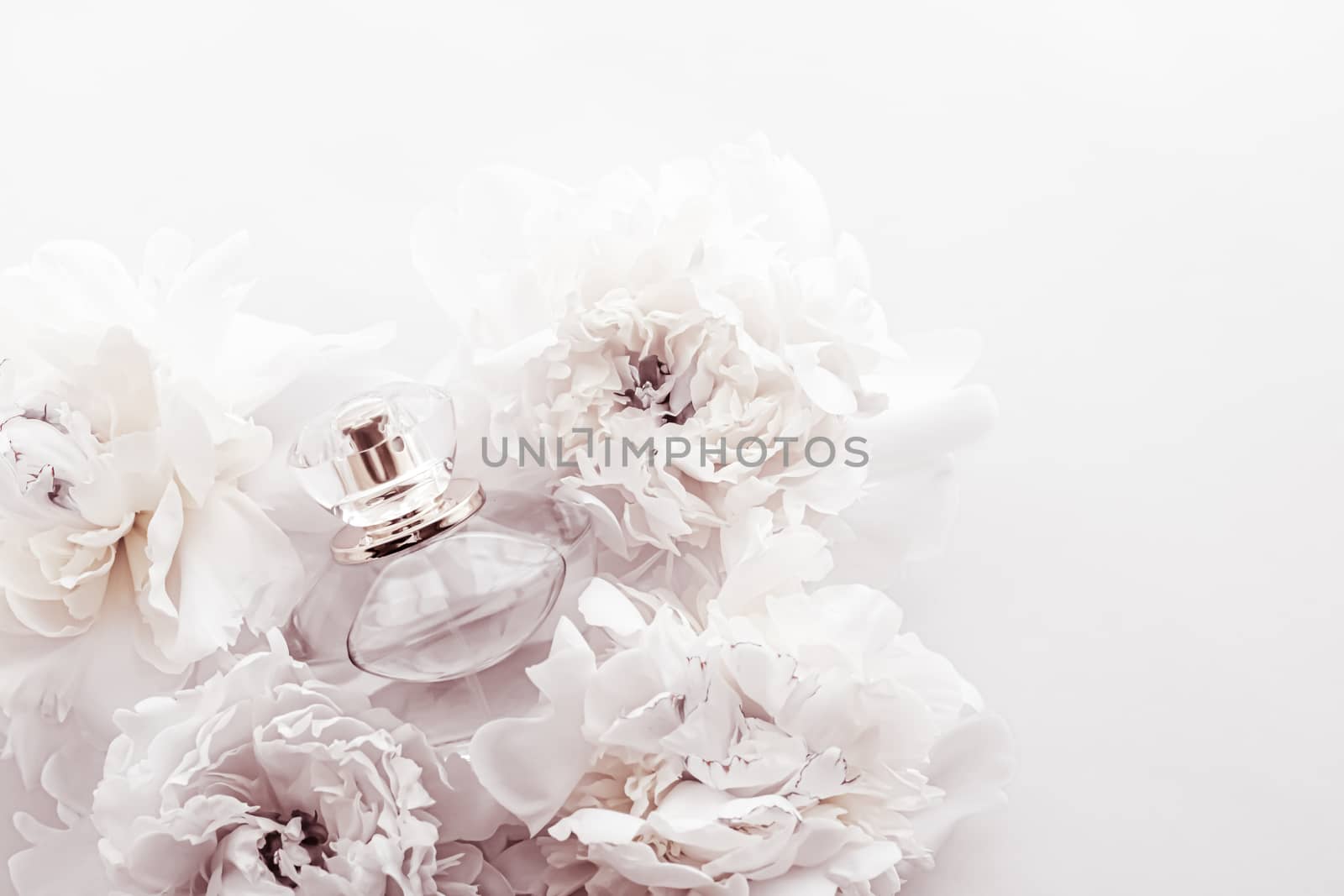 Chic fragrance bottle as luxe perfume product on background of peony flowers, parfum ad and beauty branding design