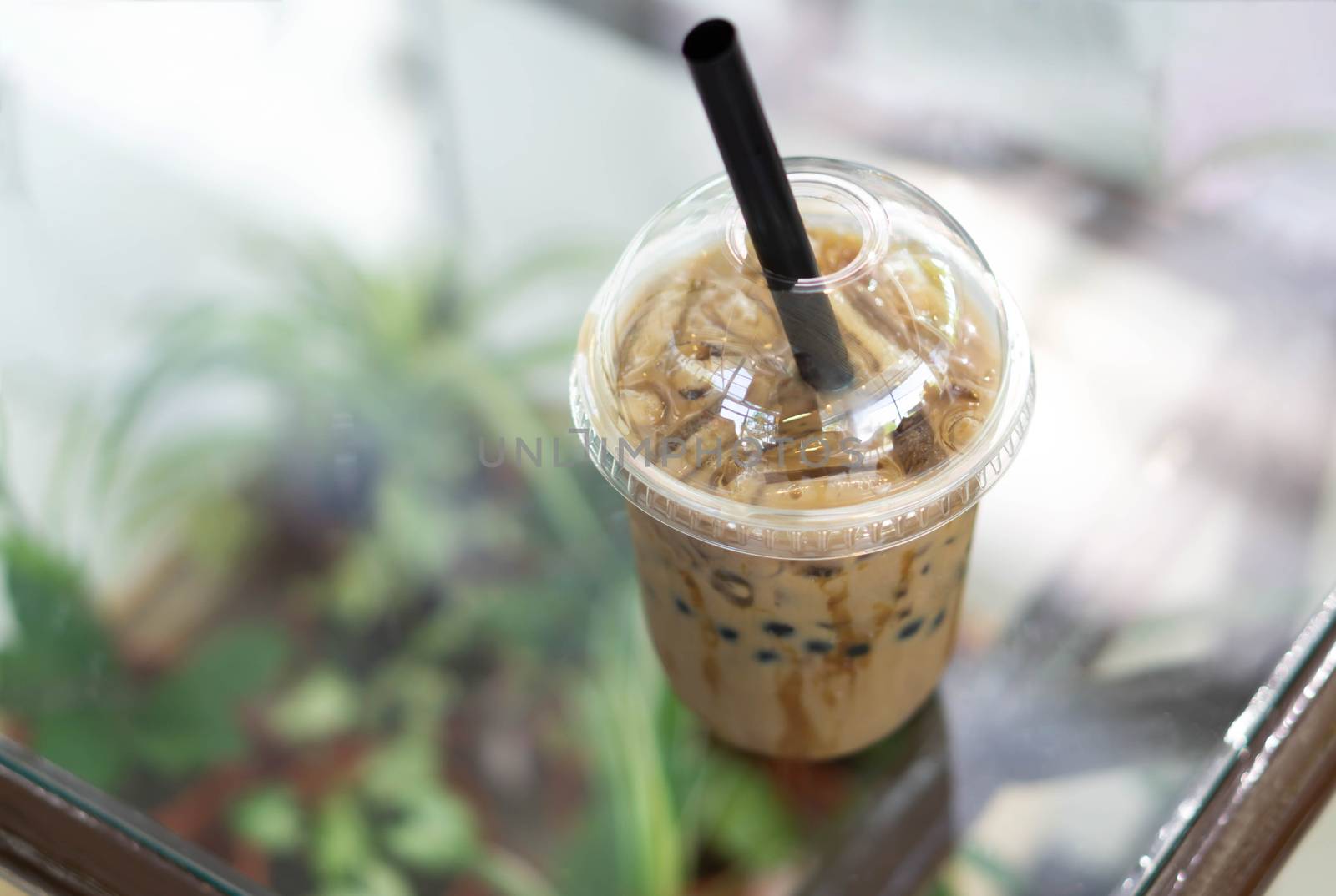 Closeup ice coffee on wood table with nature background