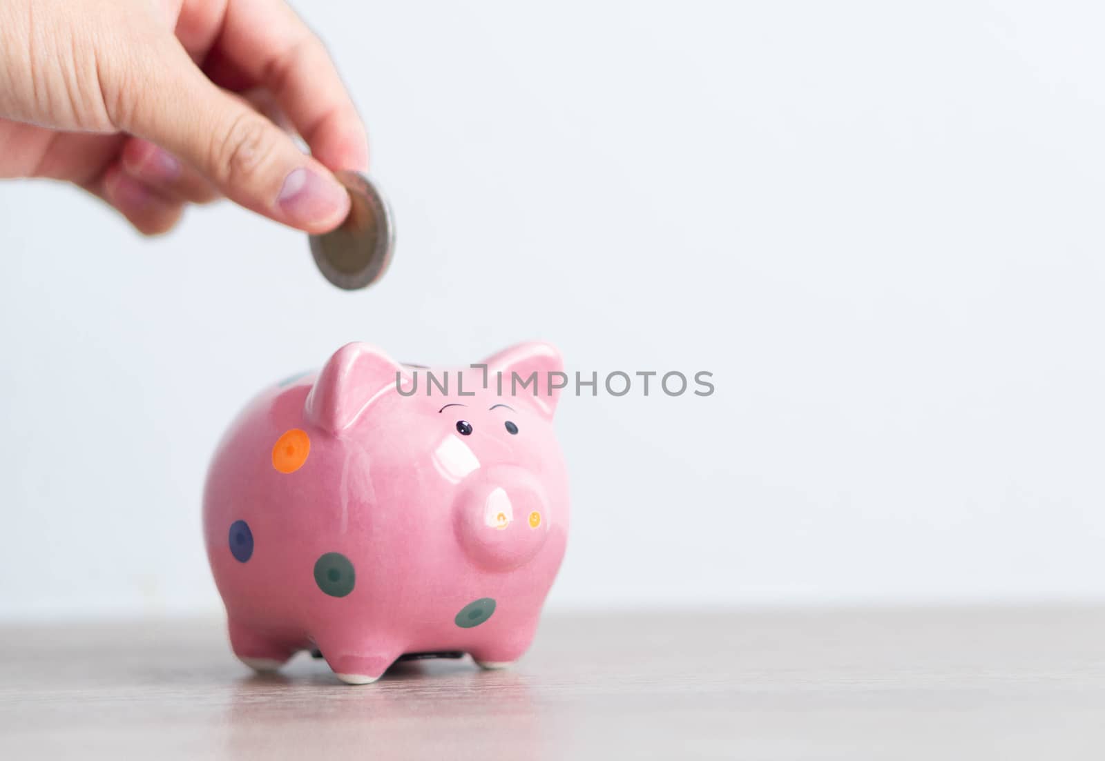 Pink ceramic piggy bank on white background, saving money concept