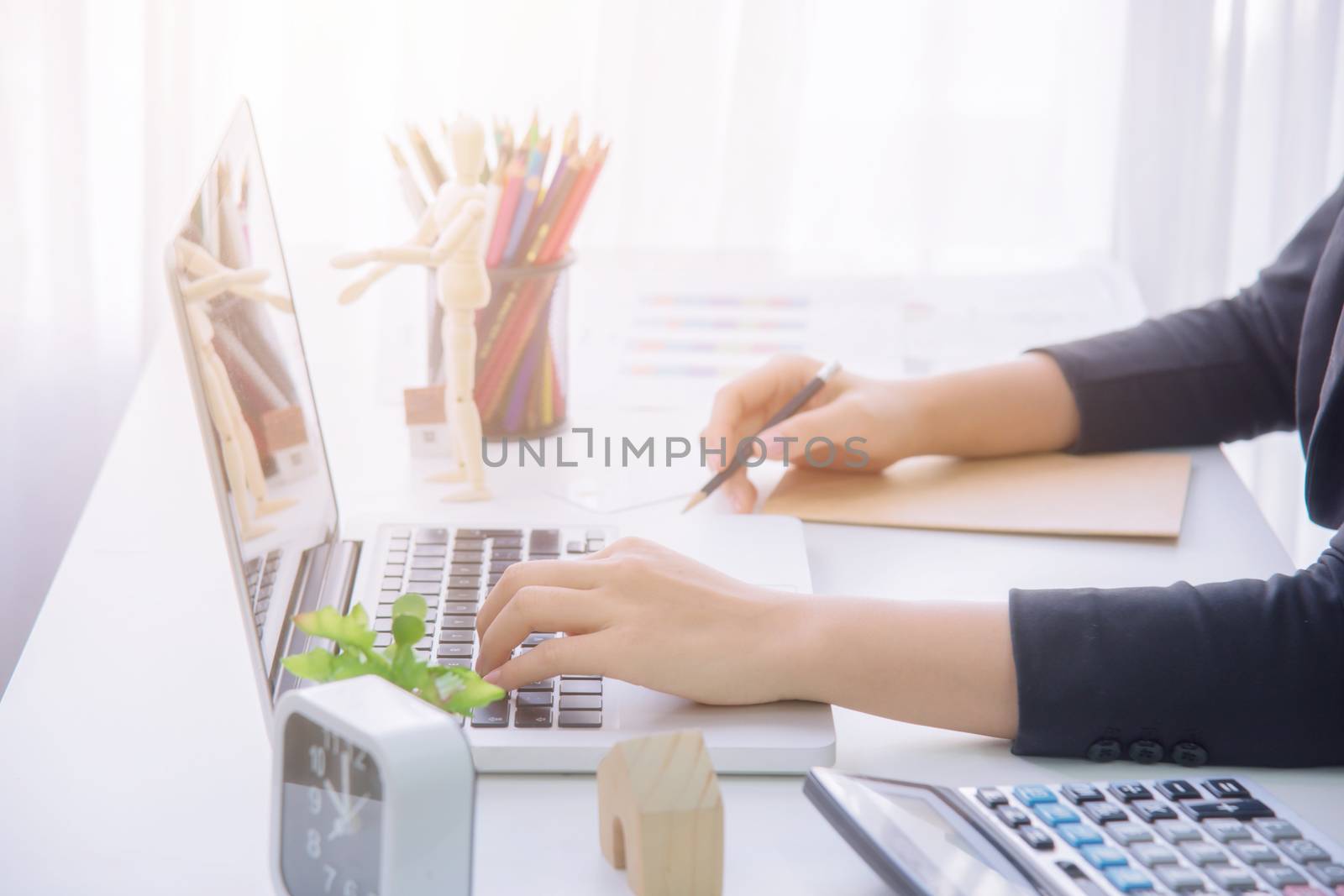 A young business woman using laptop computer. by NuwatPhoto