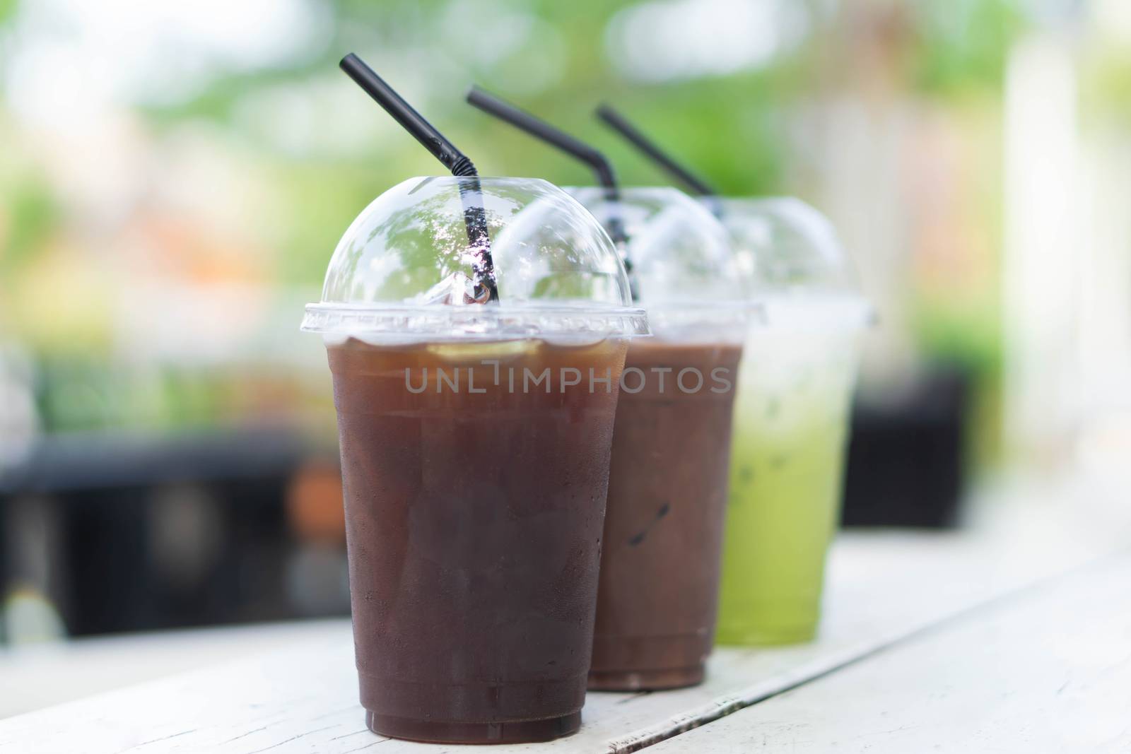 Close up glass of ice matcha green tea and ice coffee on wood table, selective focus