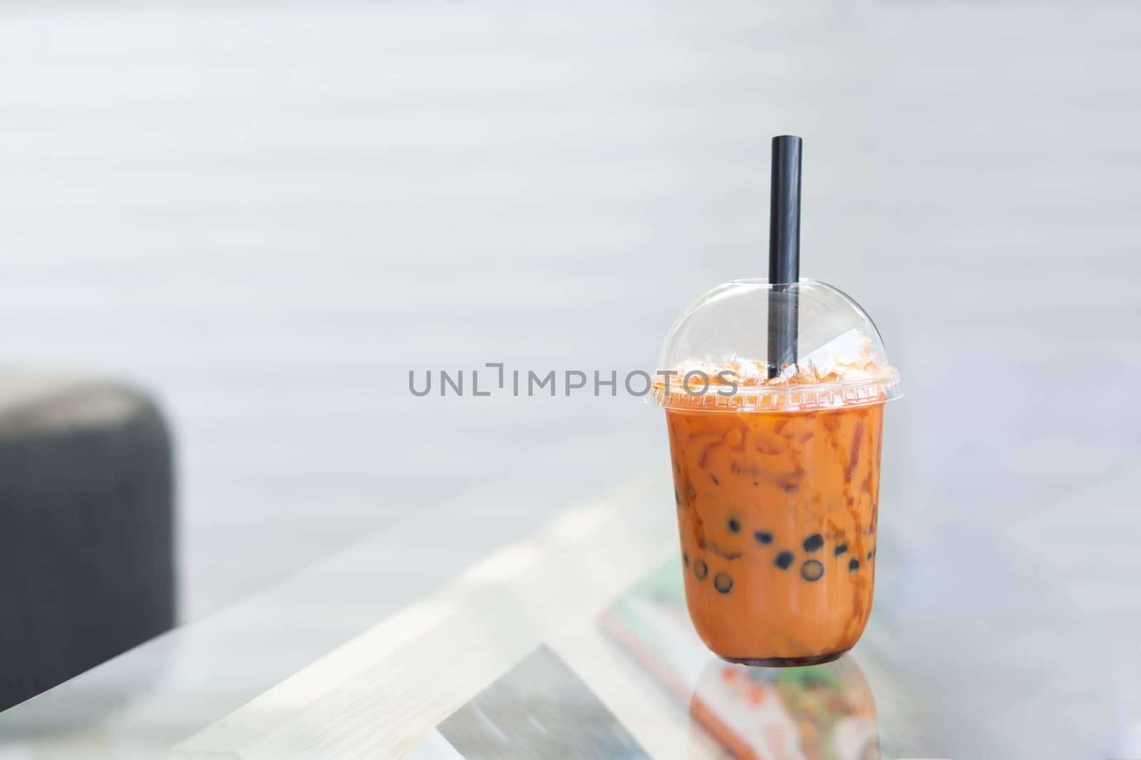 Closeup thai tea on wood table with nature background