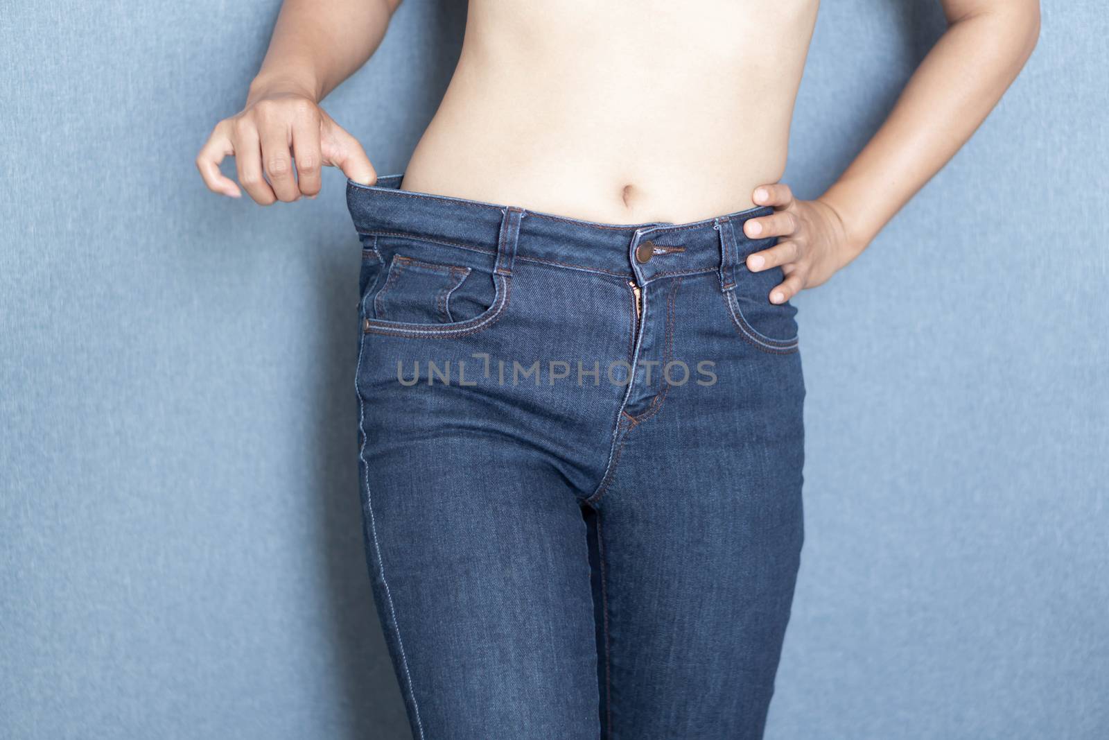 Woman showing jeans pants and body after weight loss and sexy body
