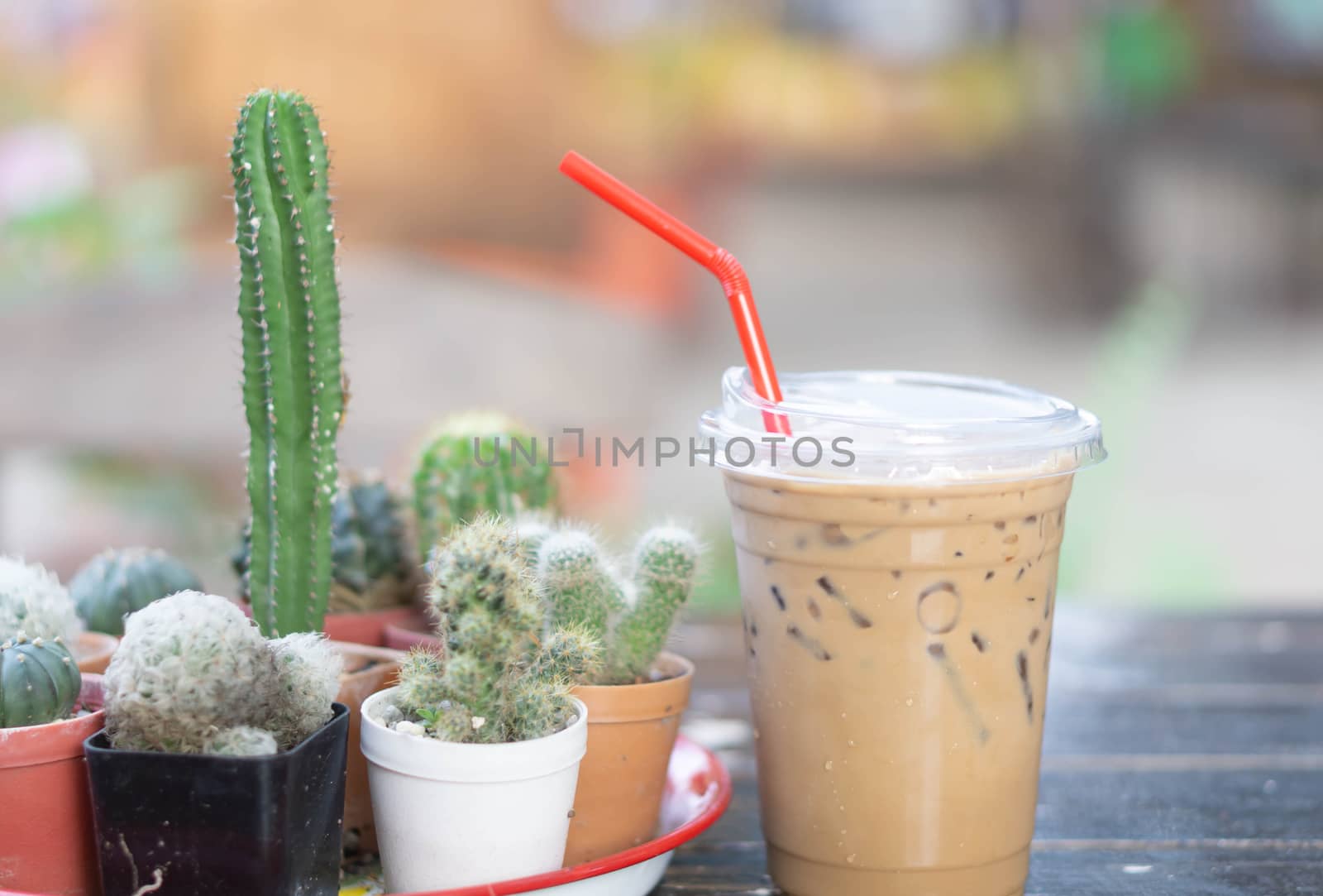 Close up glass of ice cappuccino coffee on wood table  background, selective focus