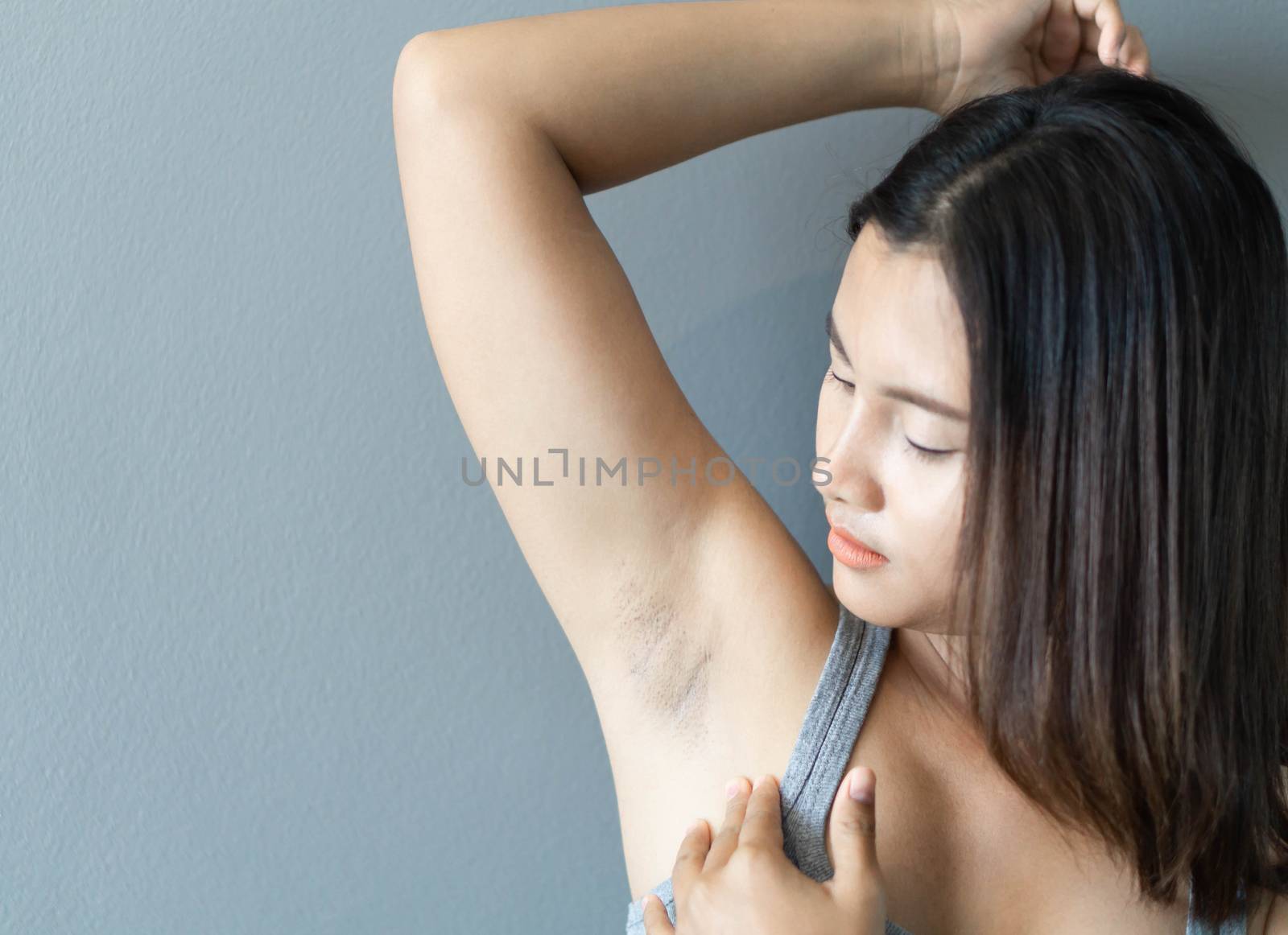 Women problem black armpit lying on white bed background for ski by pt.pongsak@gmail.com