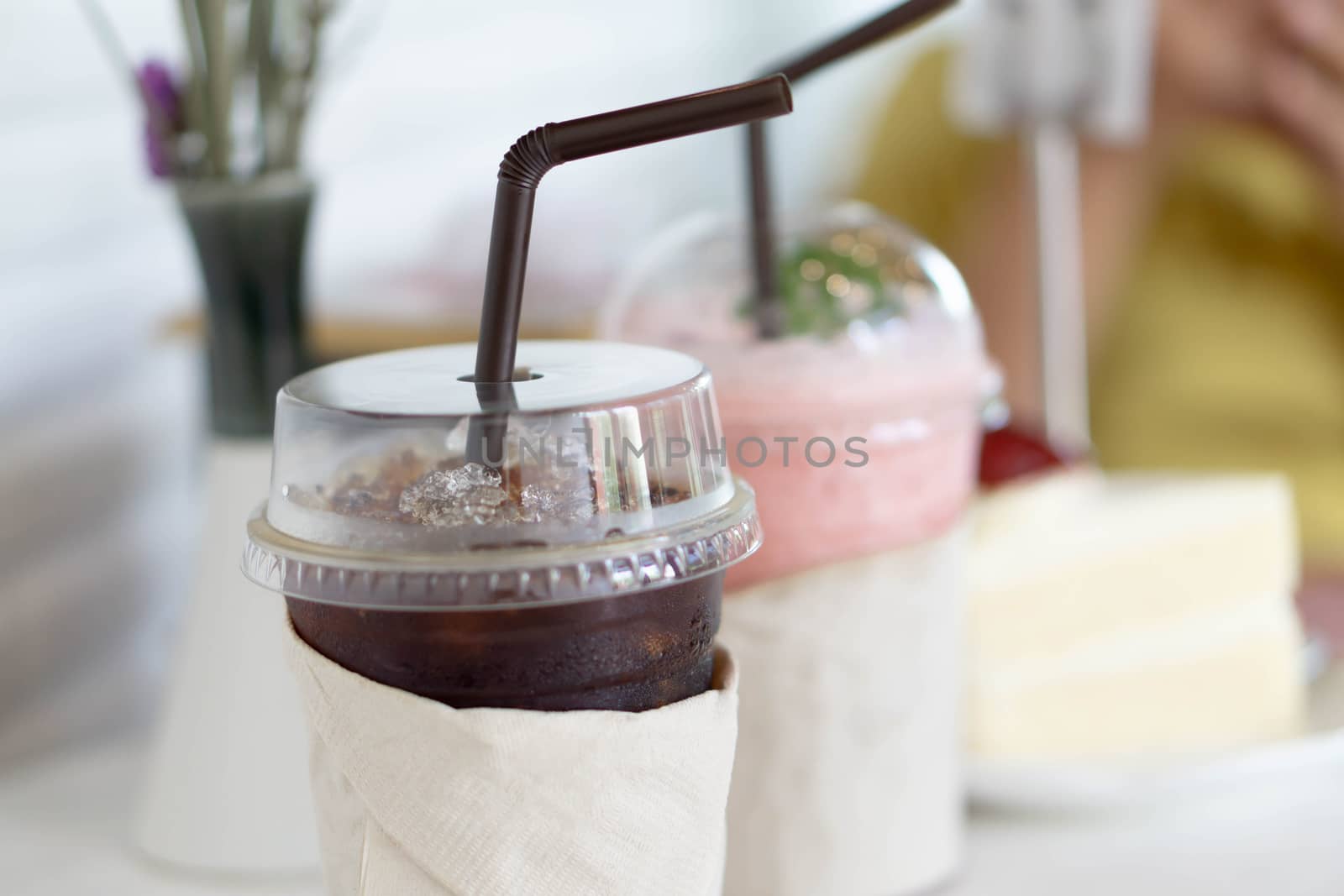Closeup glass of ice americano on wood table in coffee shop