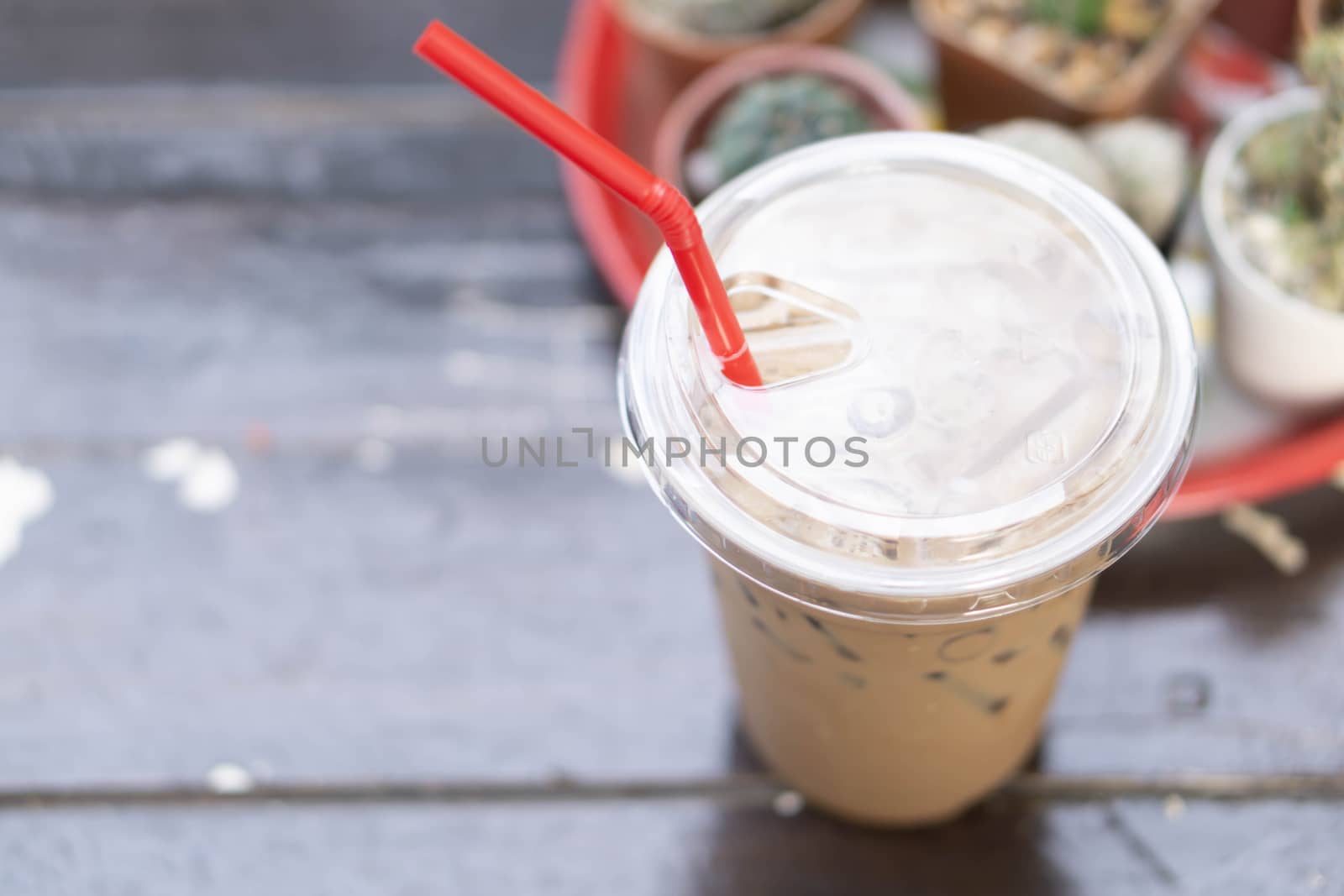Close up glass of ice cappuccino coffee on wood table  background, selective focus