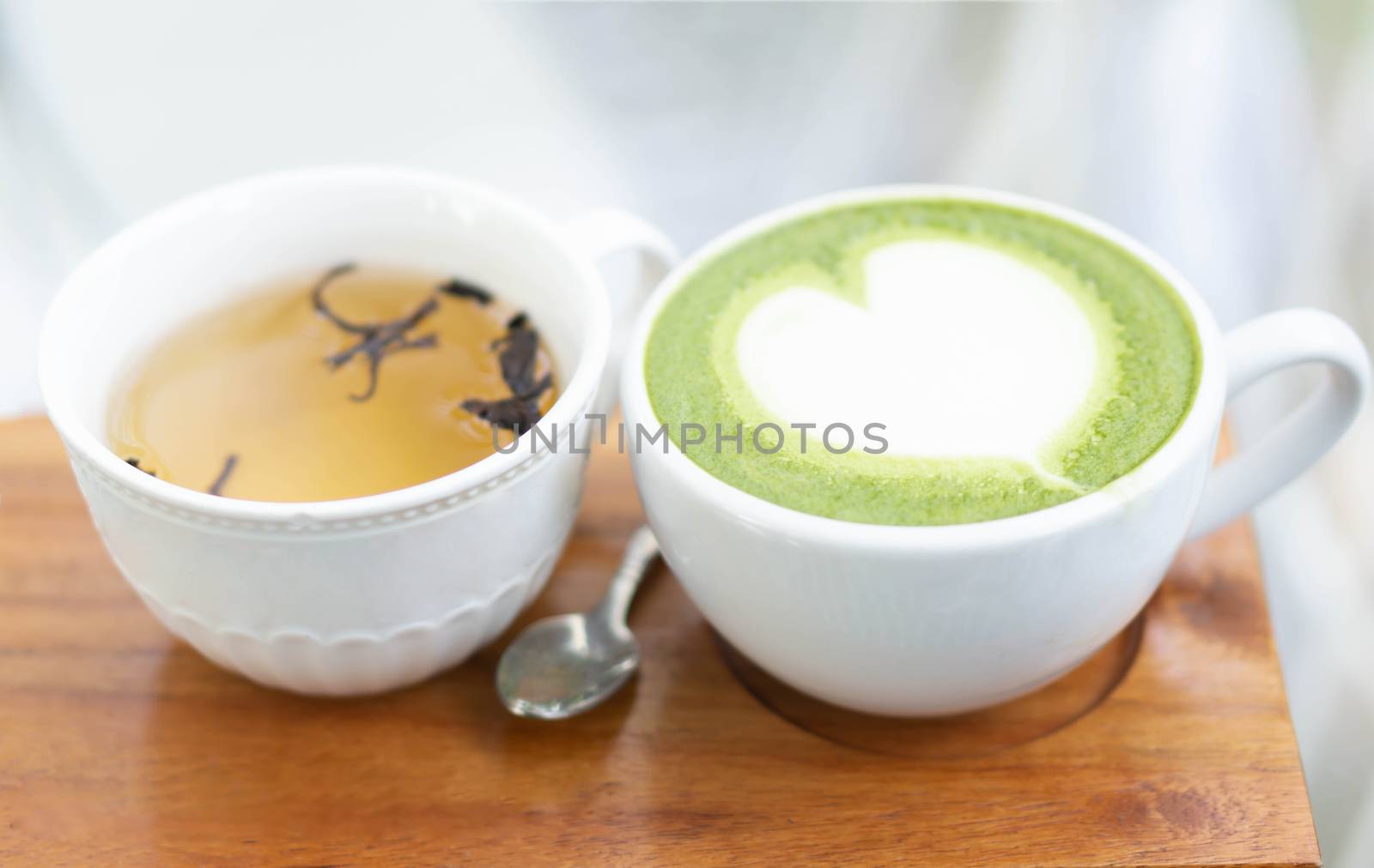 Closeup glass of latte art coffee tulip shape on wood background with vintage color, selective focus