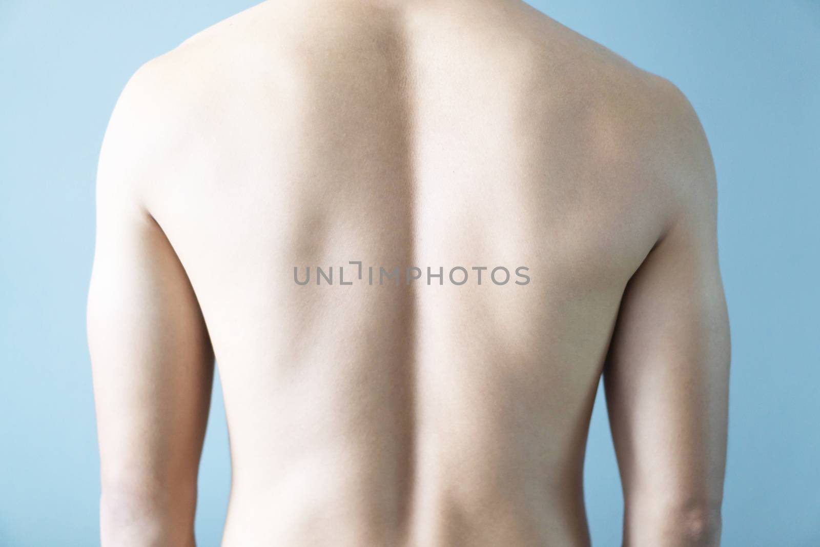 Back of man on blue background, beauty healthy skin care for men concept