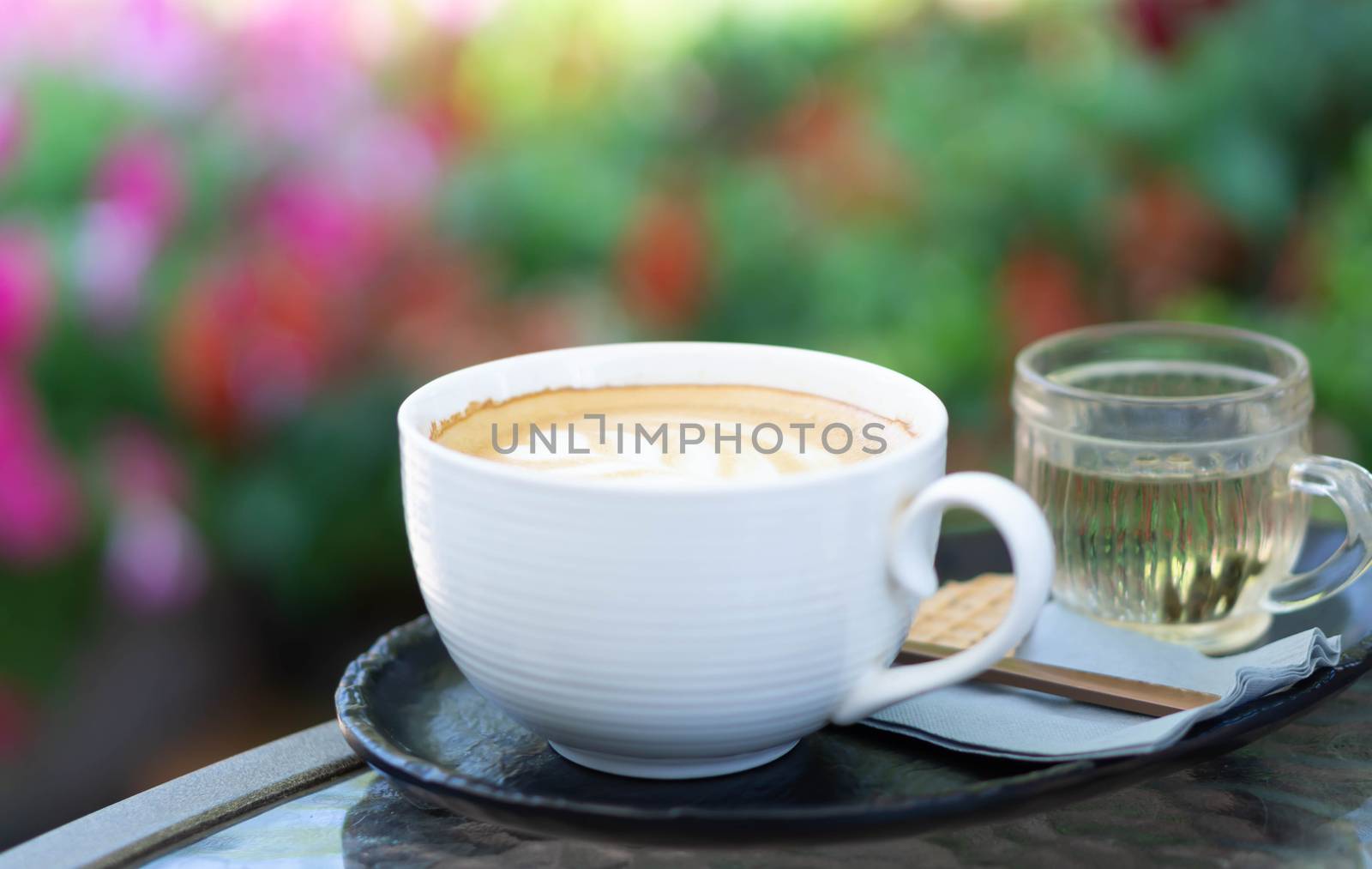 Closeup glass of latte art coffee tulip shape on wood background with vintage color, selective focus