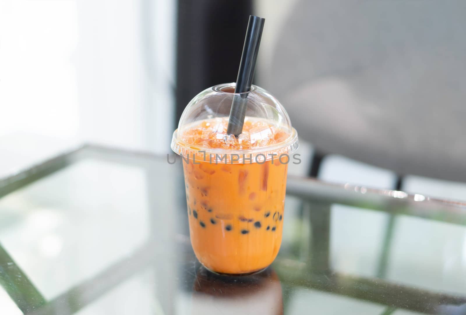 Closeup thai tea on wood table with nature background