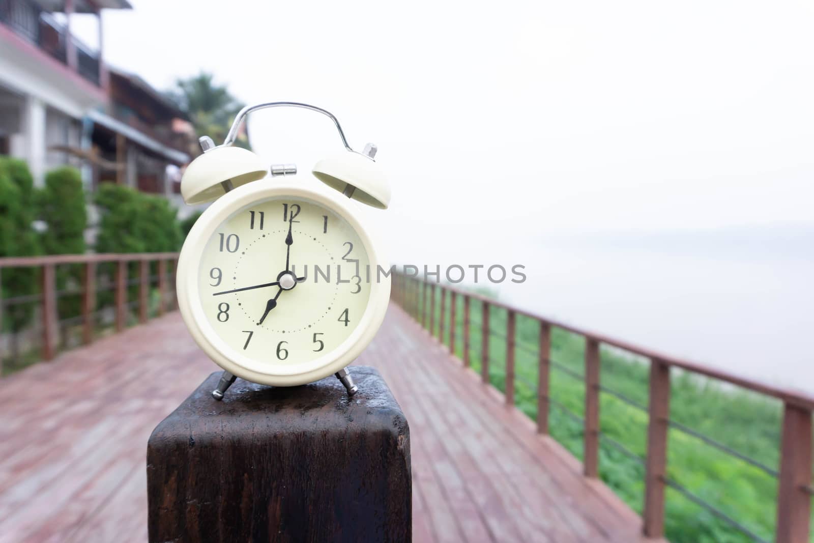 Alarm clock with nature and fog background in the morning