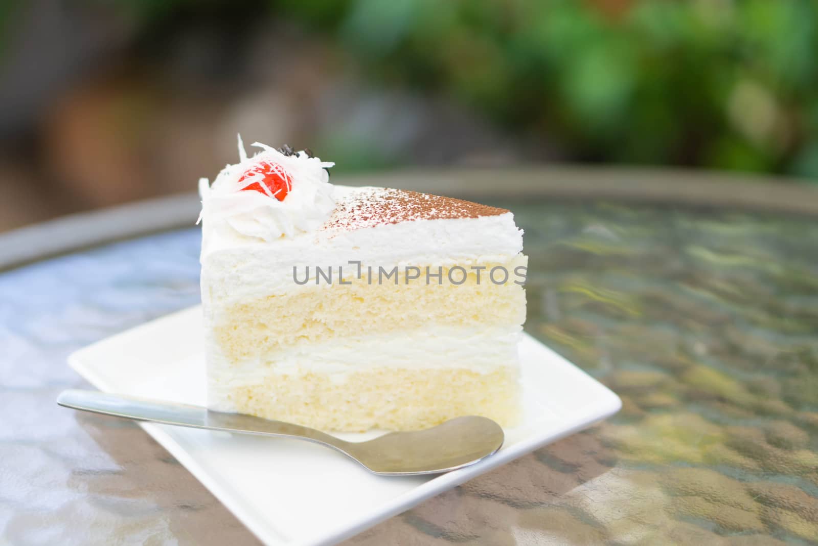 Closeup Milk cake delicious on glass table background, selective focus
