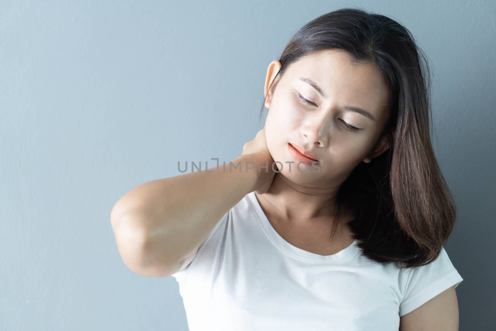 Closeup woman holding neck with pain after waking up on bed, hea by pt.pongsak@gmail.com