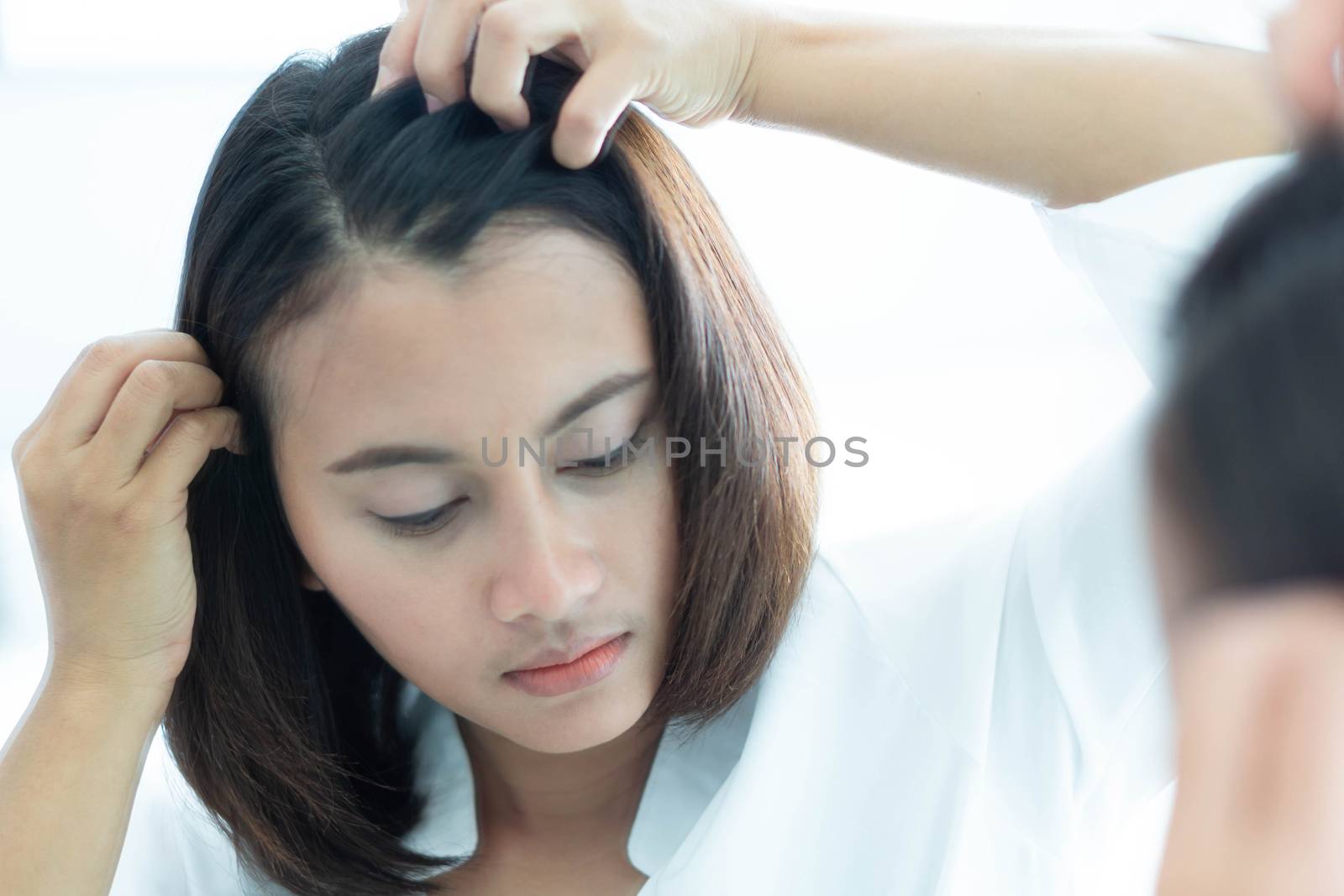 Woman looking reflection in the mirror serious hair loss problem by pt.pongsak@gmail.com