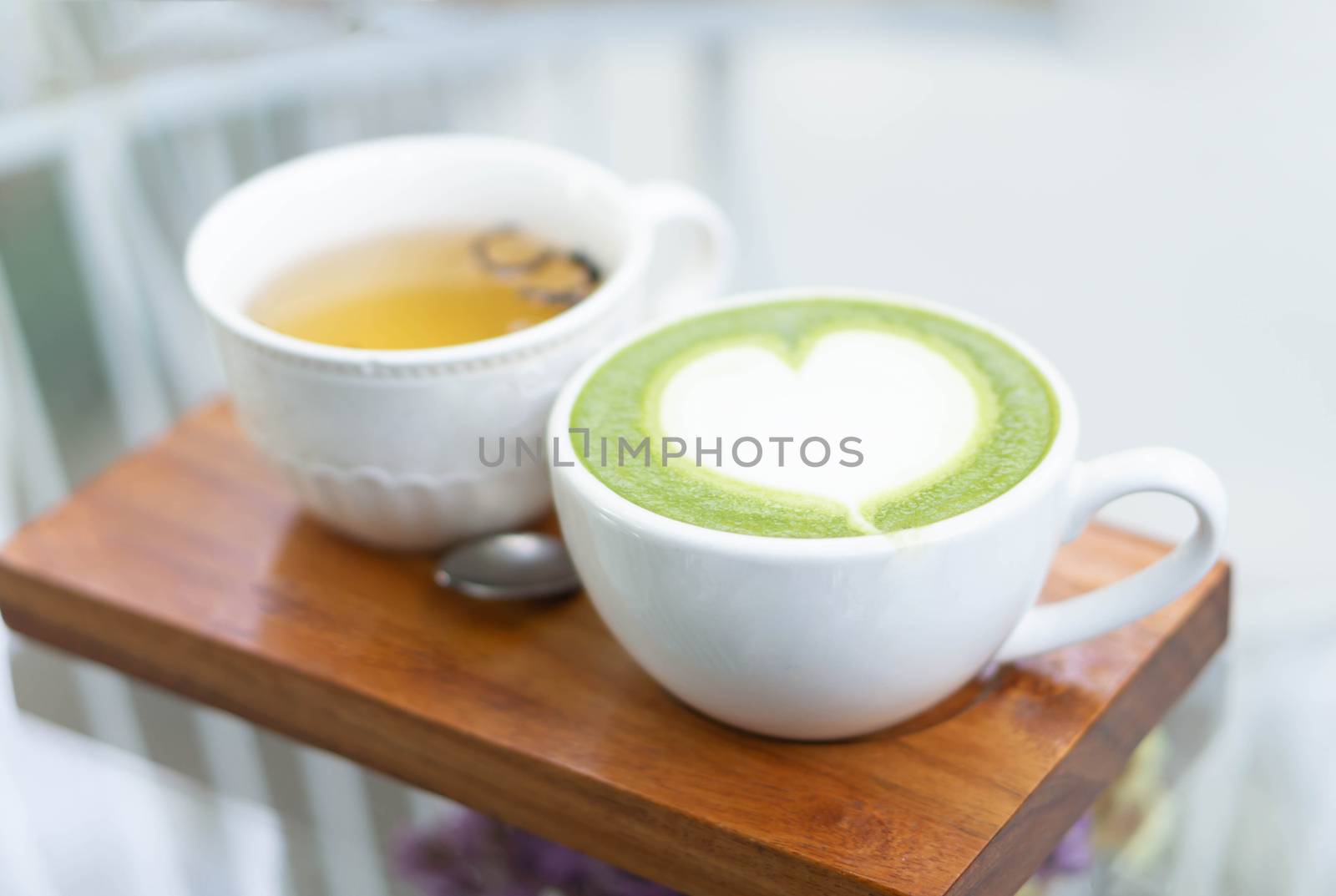 Closeup glass of latte art coffee tulip shape on wood background with vintage color, selective focus