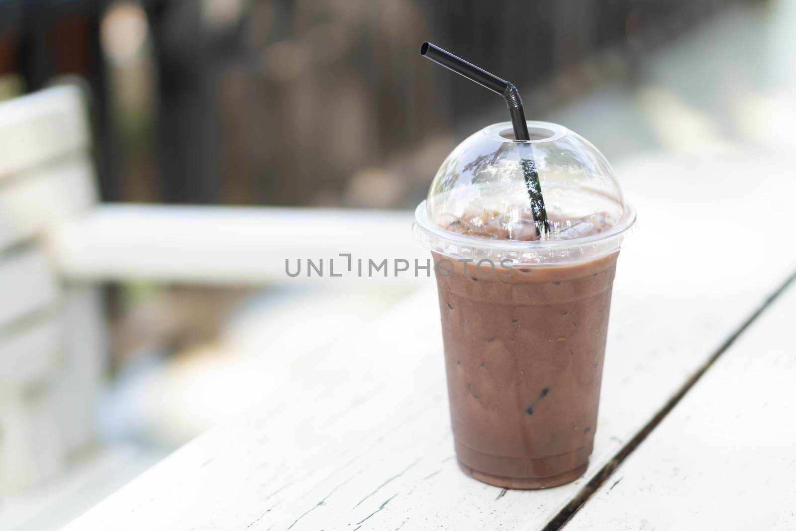 Close up glass of ice chocolate on wood table, selective focus