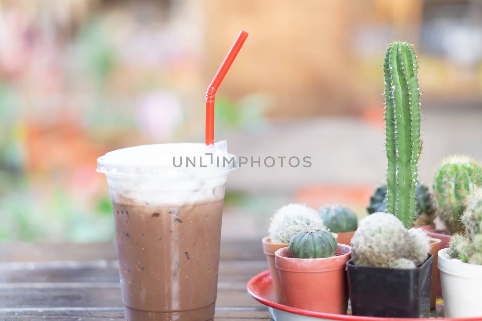 Close up glass of ice cappuccino coffee on wood table  background, selective focus