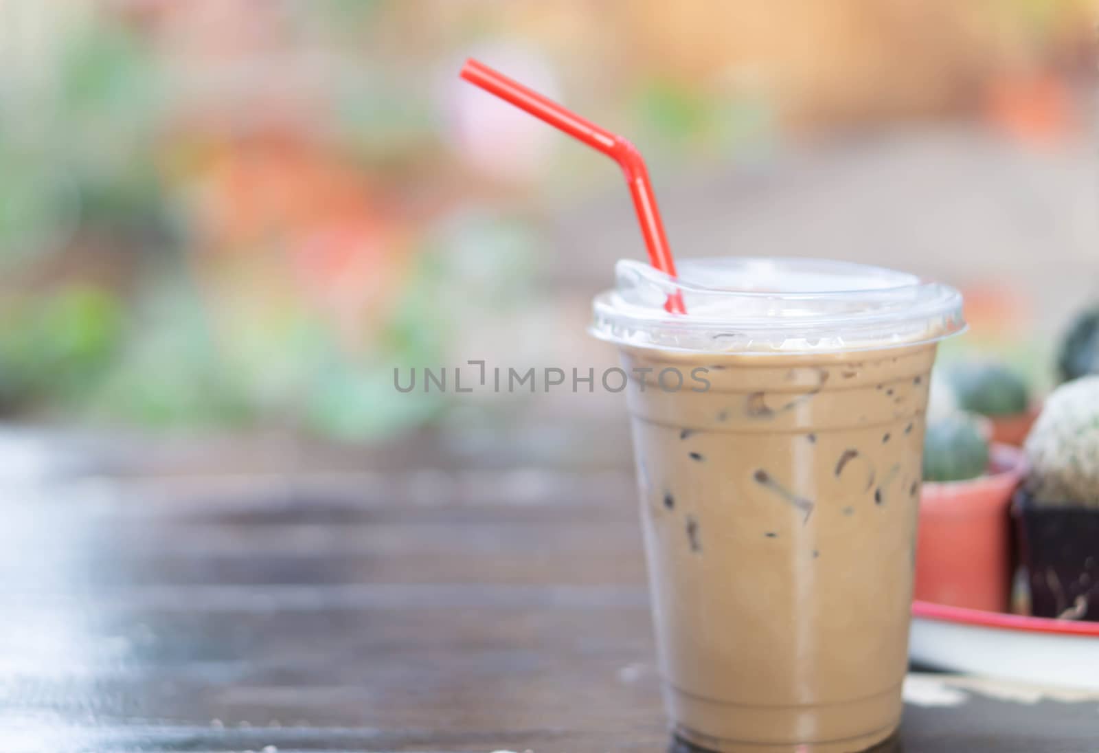 Close up glass of ice cappuccino coffee on wood table  background, selective focus