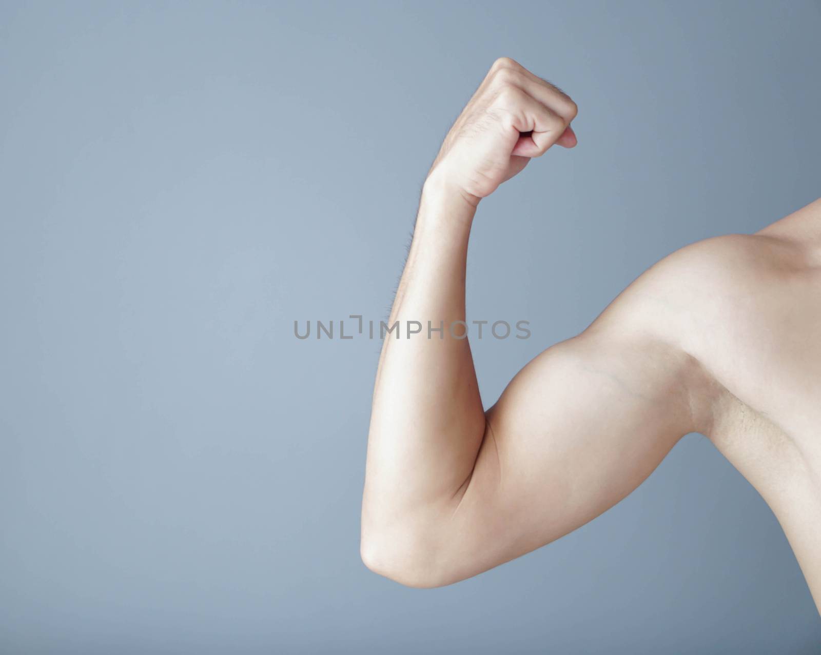 Man arm with muscle on grey background, health care and medical concept