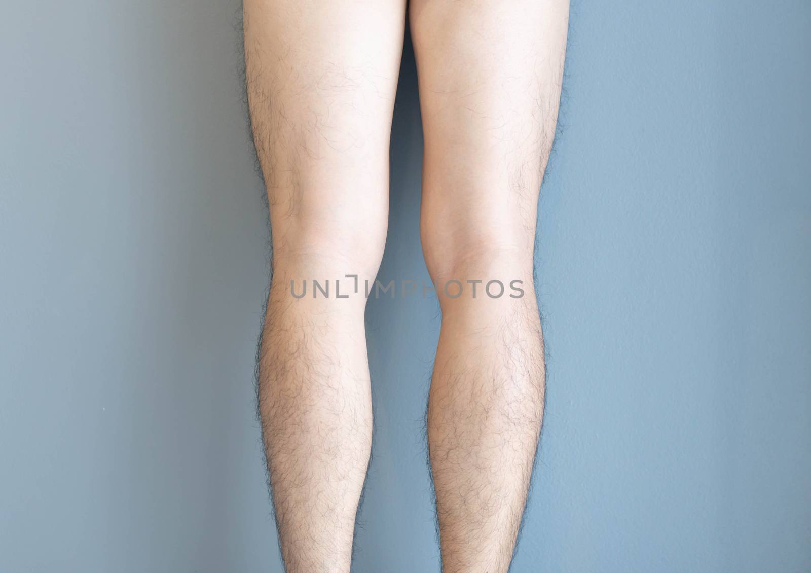 Closeup back of legs men skin and hairy for health care concept with grey background