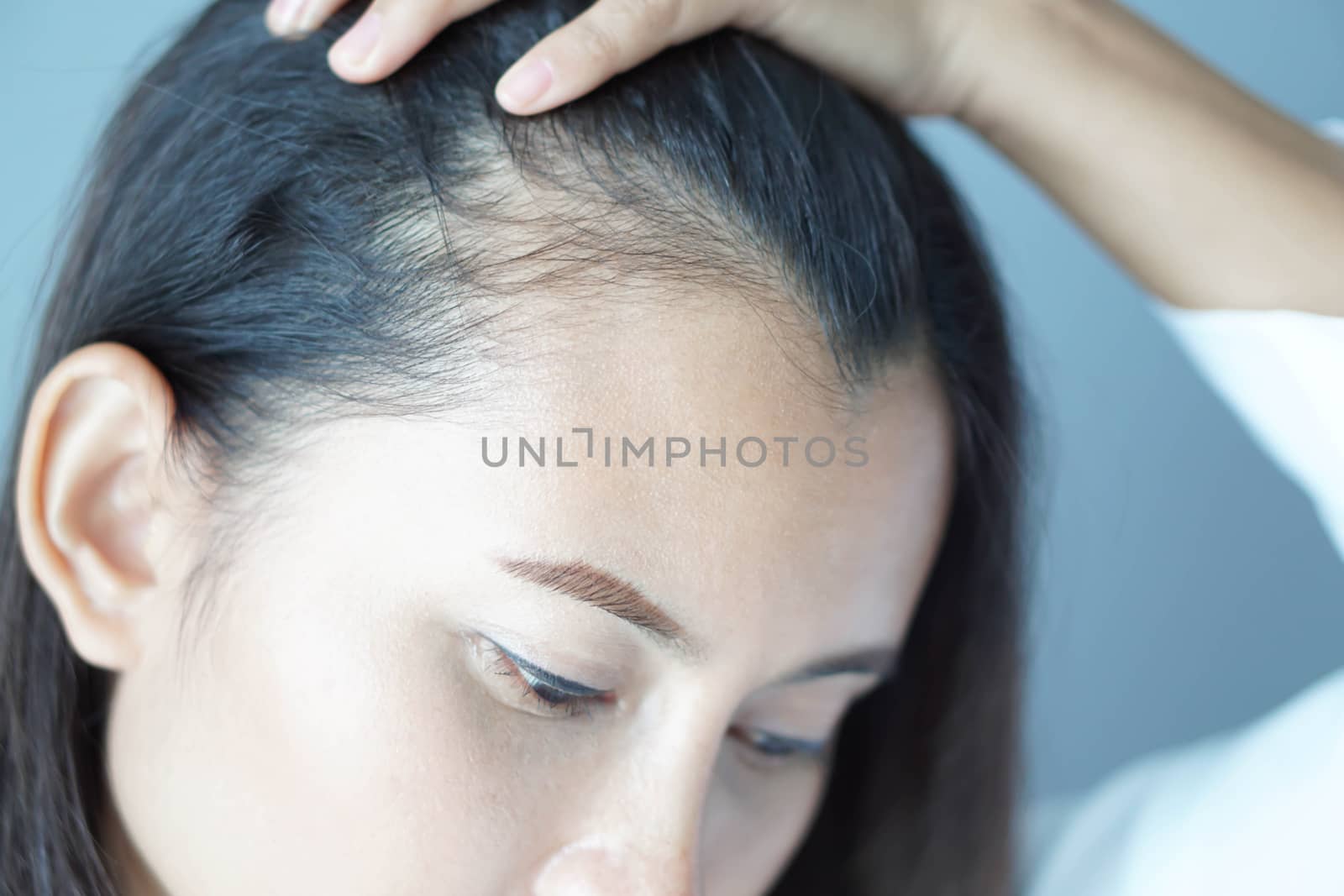 Woman looking reflection in the mirror serious hair loss problem for health care shampoo and beauty product concept