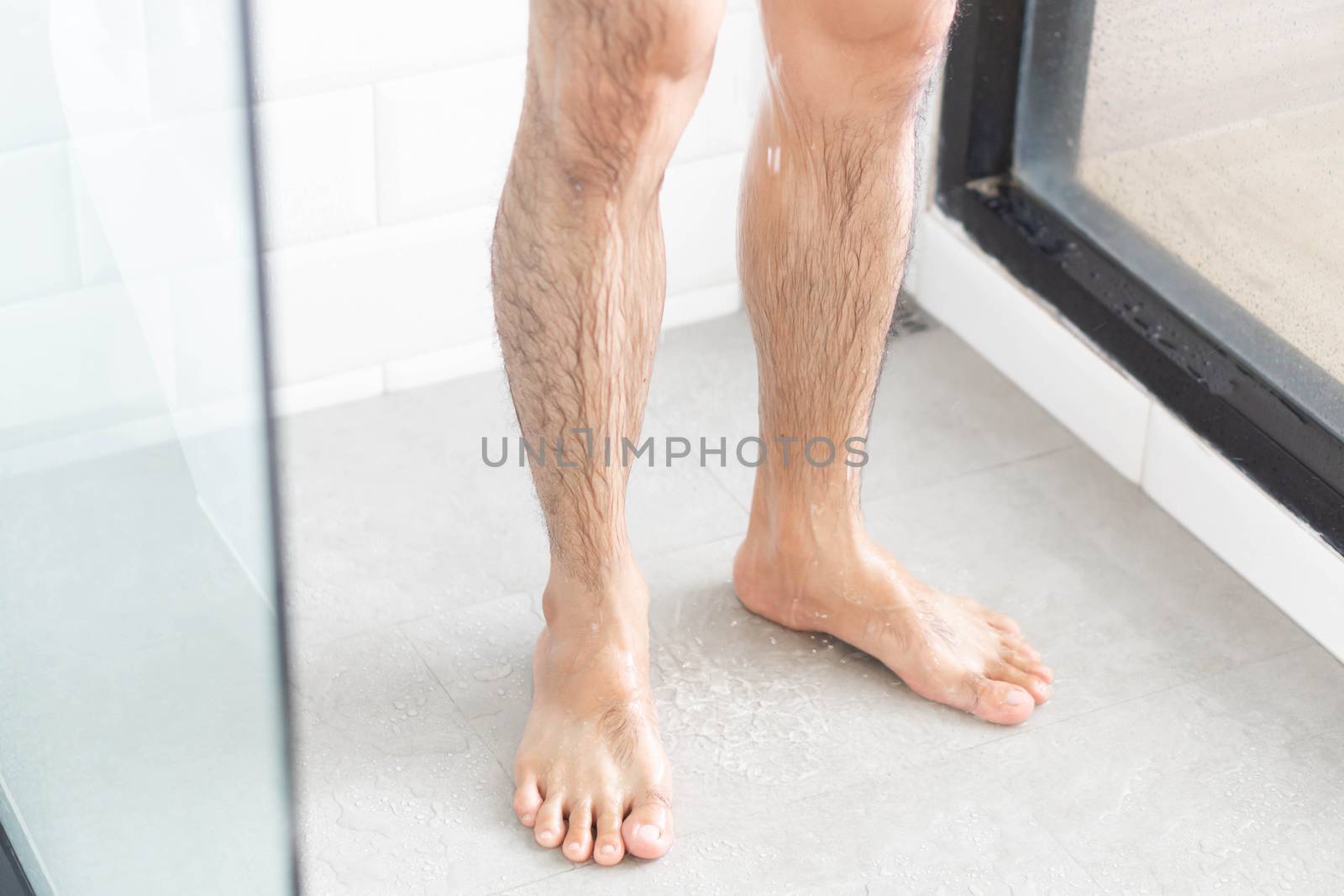 Close up man legs with taking a shower in the bathroom, health c by pt.pongsak@gmail.com