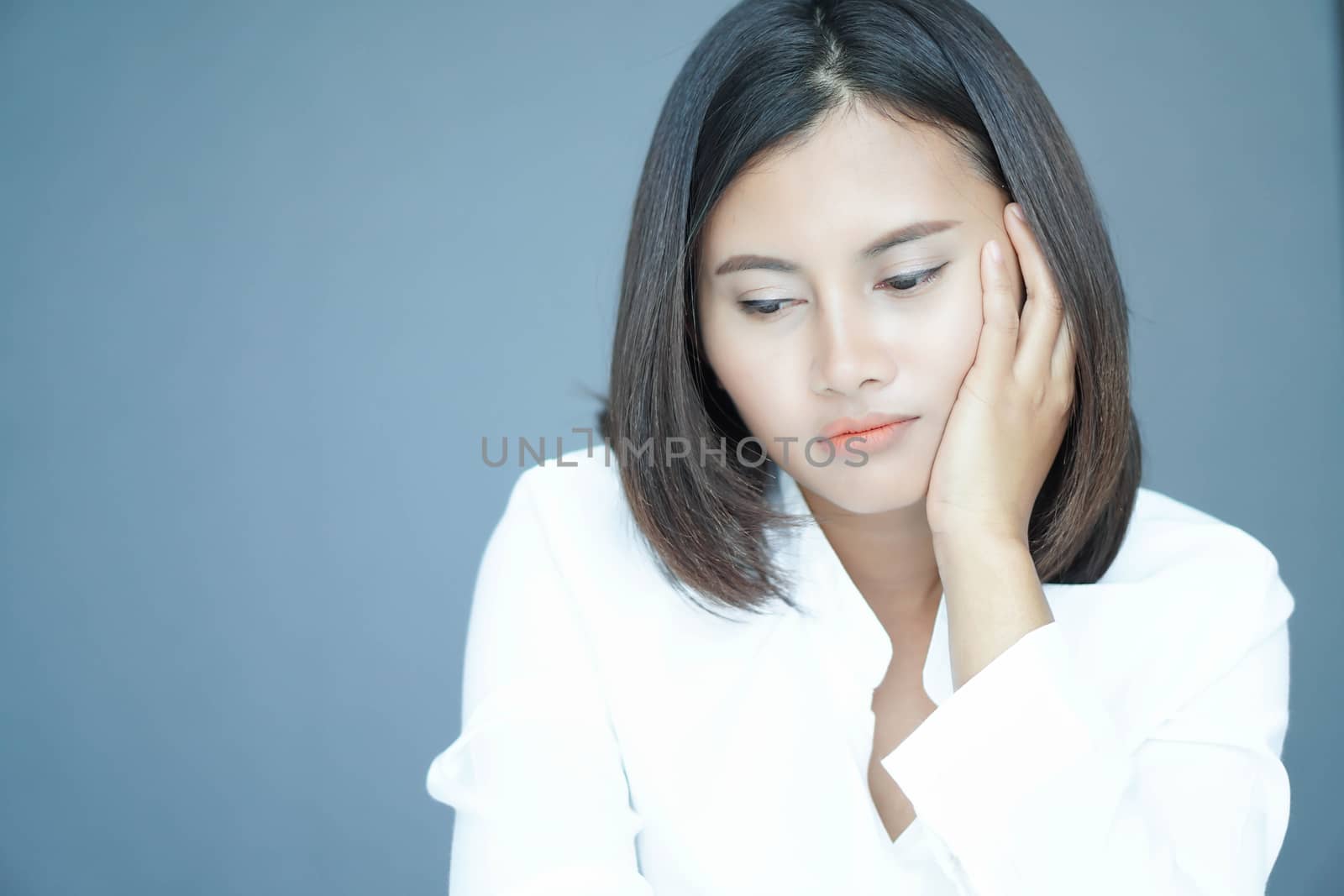 Closeup woman sitting on bed in the bedroom with depressed feeli by pt.pongsak@gmail.com