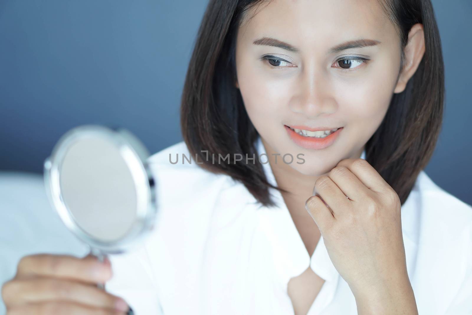 Close up face of woman looking the mirror with happy feeling, health care and beauty concept