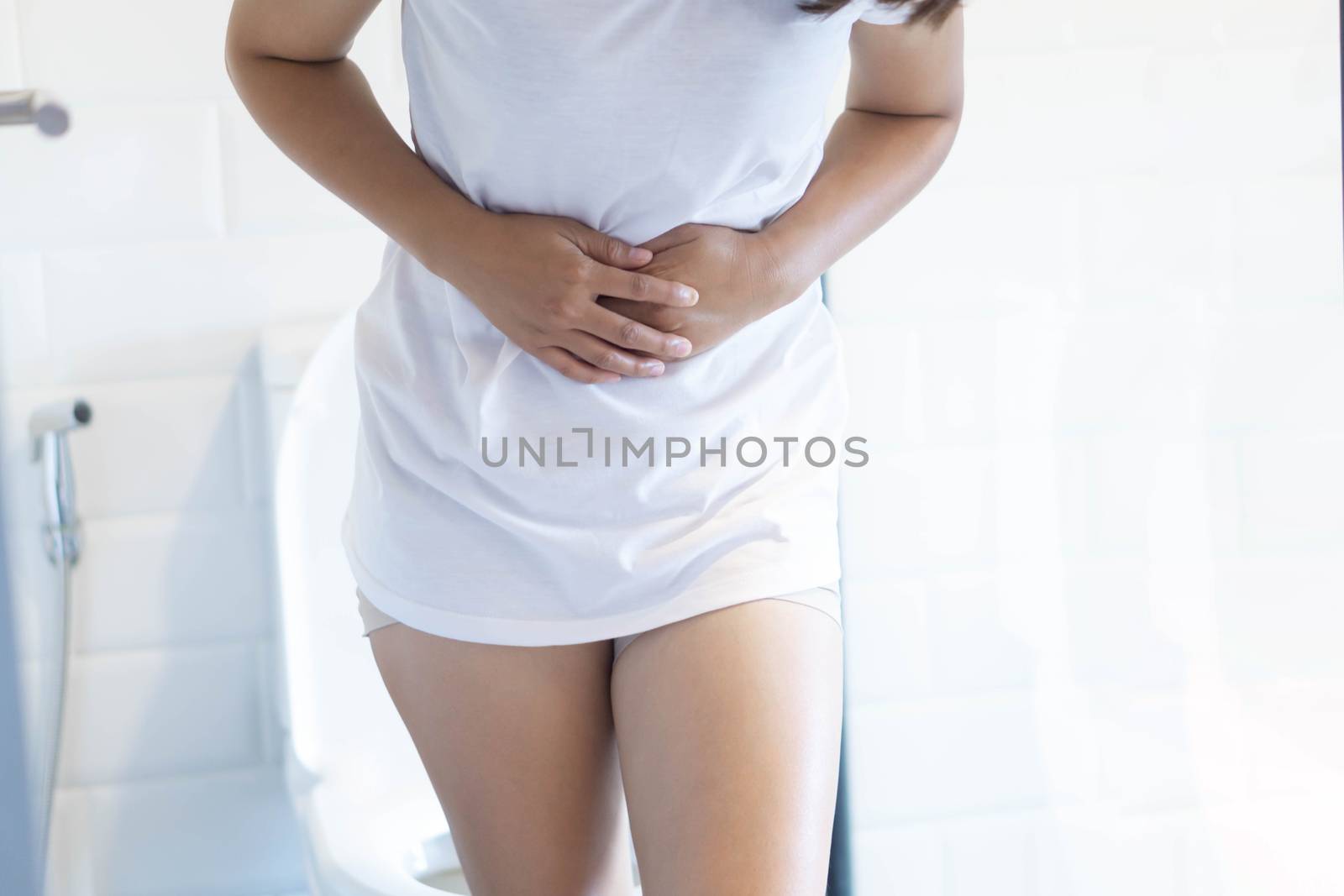 Close up woman stomachache with toilet in the morning, health ca by pt.pongsak@gmail.com