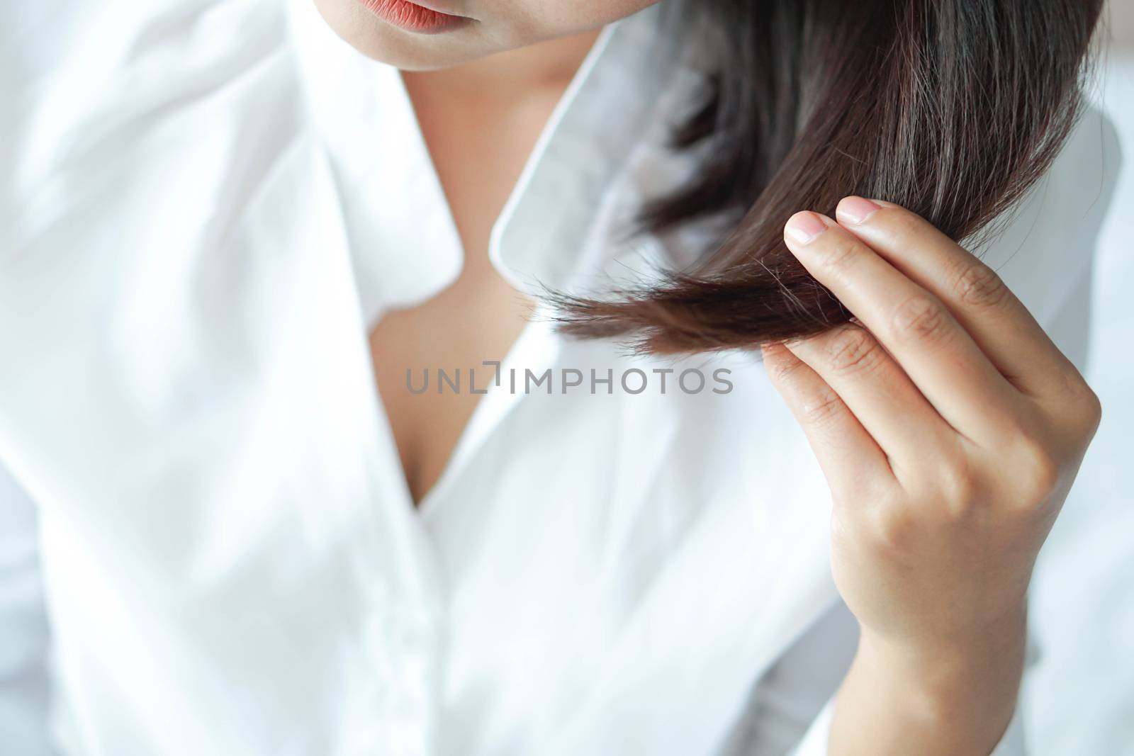 Close up woman hand holding hair loss problem for health care sh by pt.pongsak@gmail.com