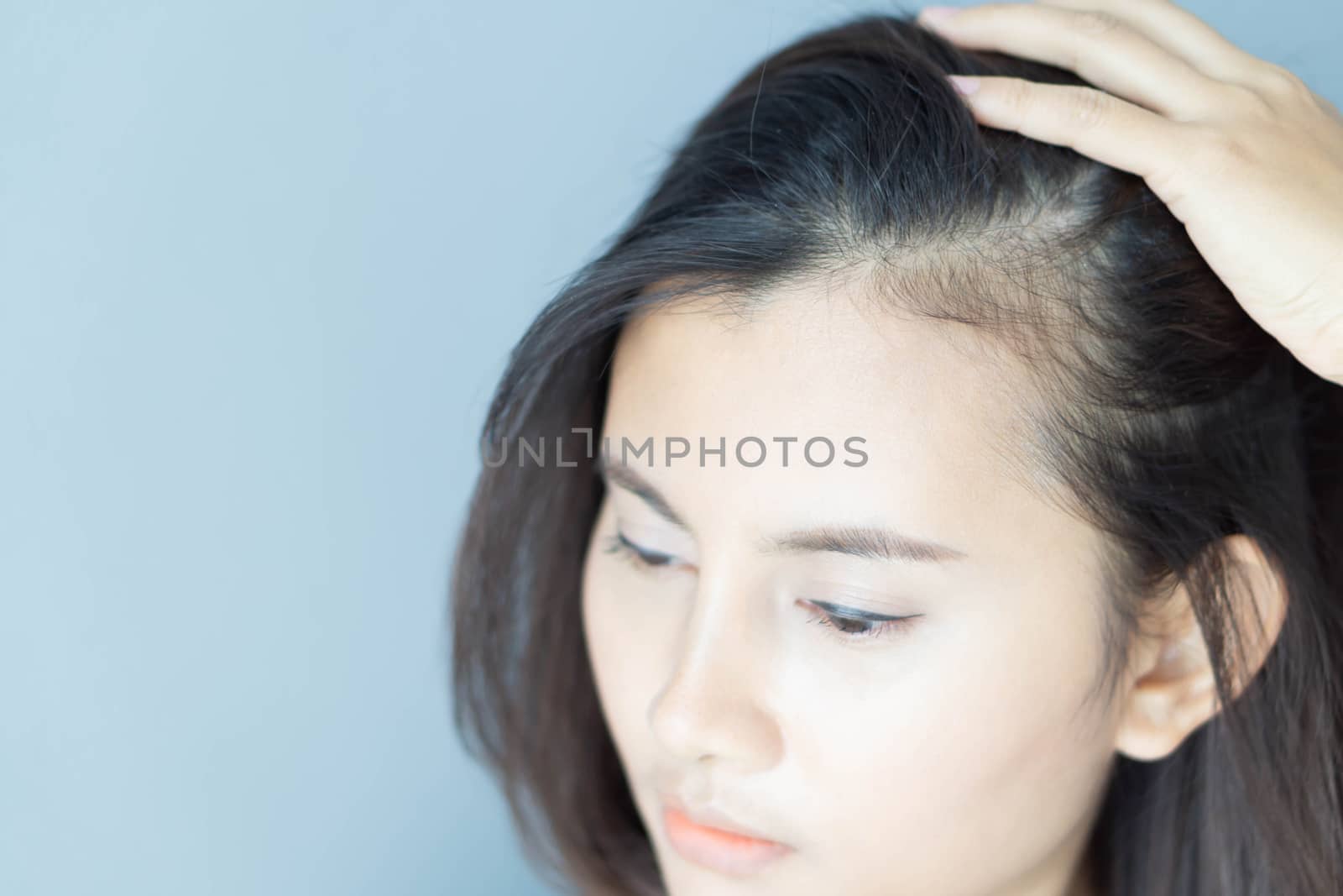 Woman looking reflection in the mirror serious hair loss problem for health care shampoo and beauty product concept