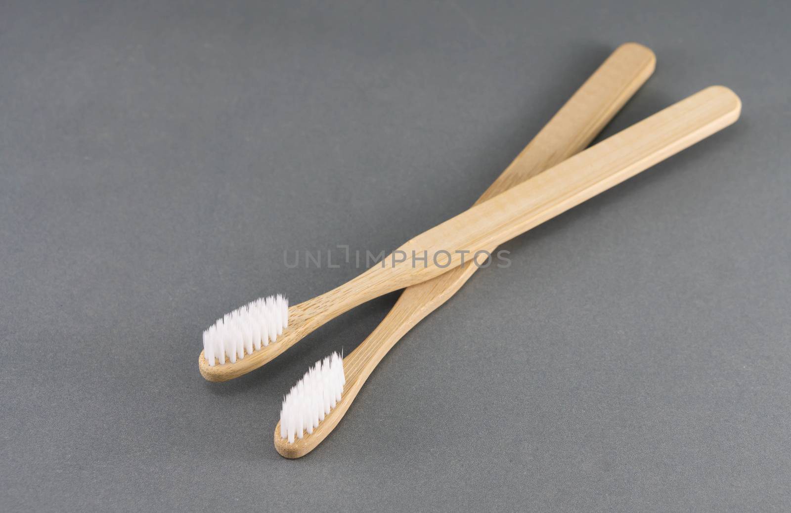 Close up wooden toothbrush on grey background, selective focus