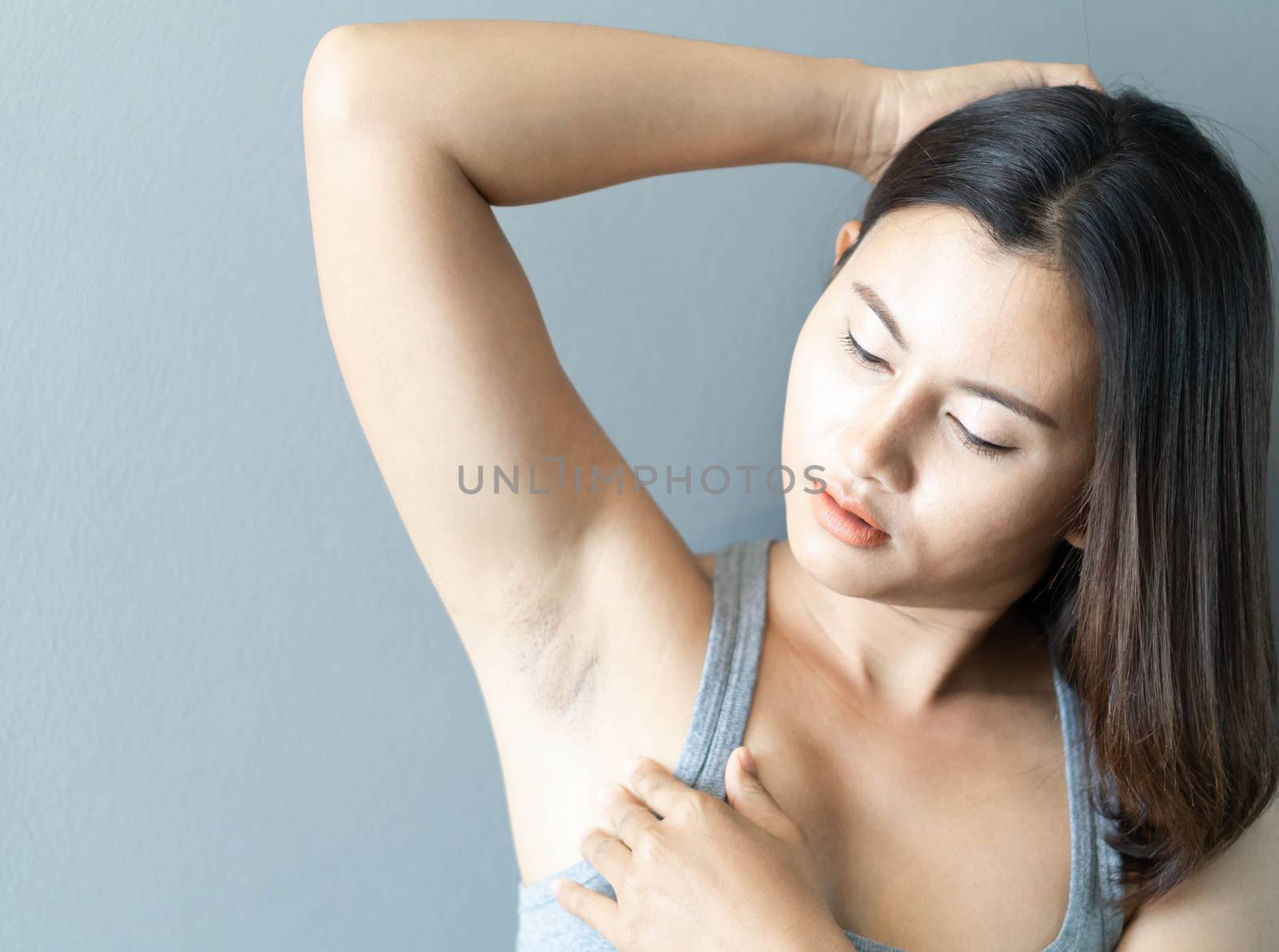 Women problem black armpit with grey background for skin care and beauty concept, selective focus