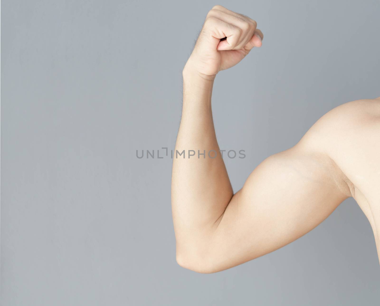 Man arm with muscle on grey background, health care and medical concept