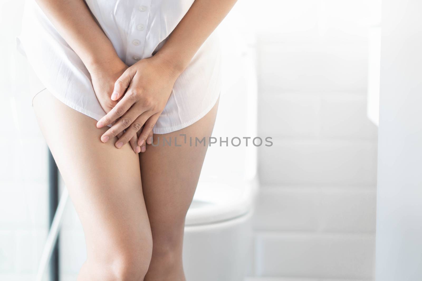 Close up woman stomachache with toilet in the morning, health care concept, selective focus