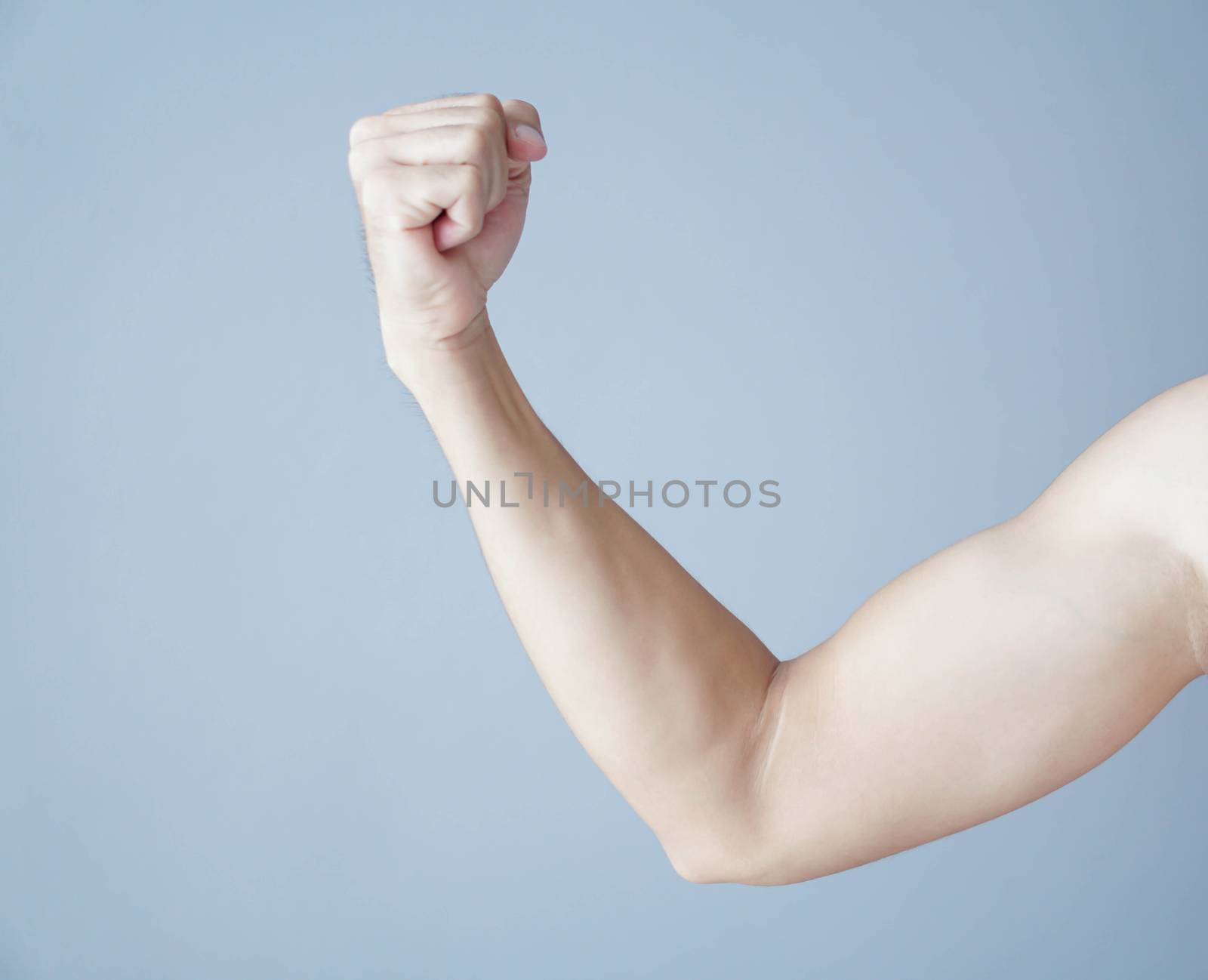 Close up arm muscle man with grey background, health care and medical concept