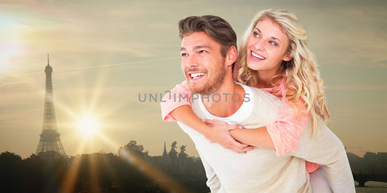 Handsome man giving piggy back to his girlfriend against eiffel tower