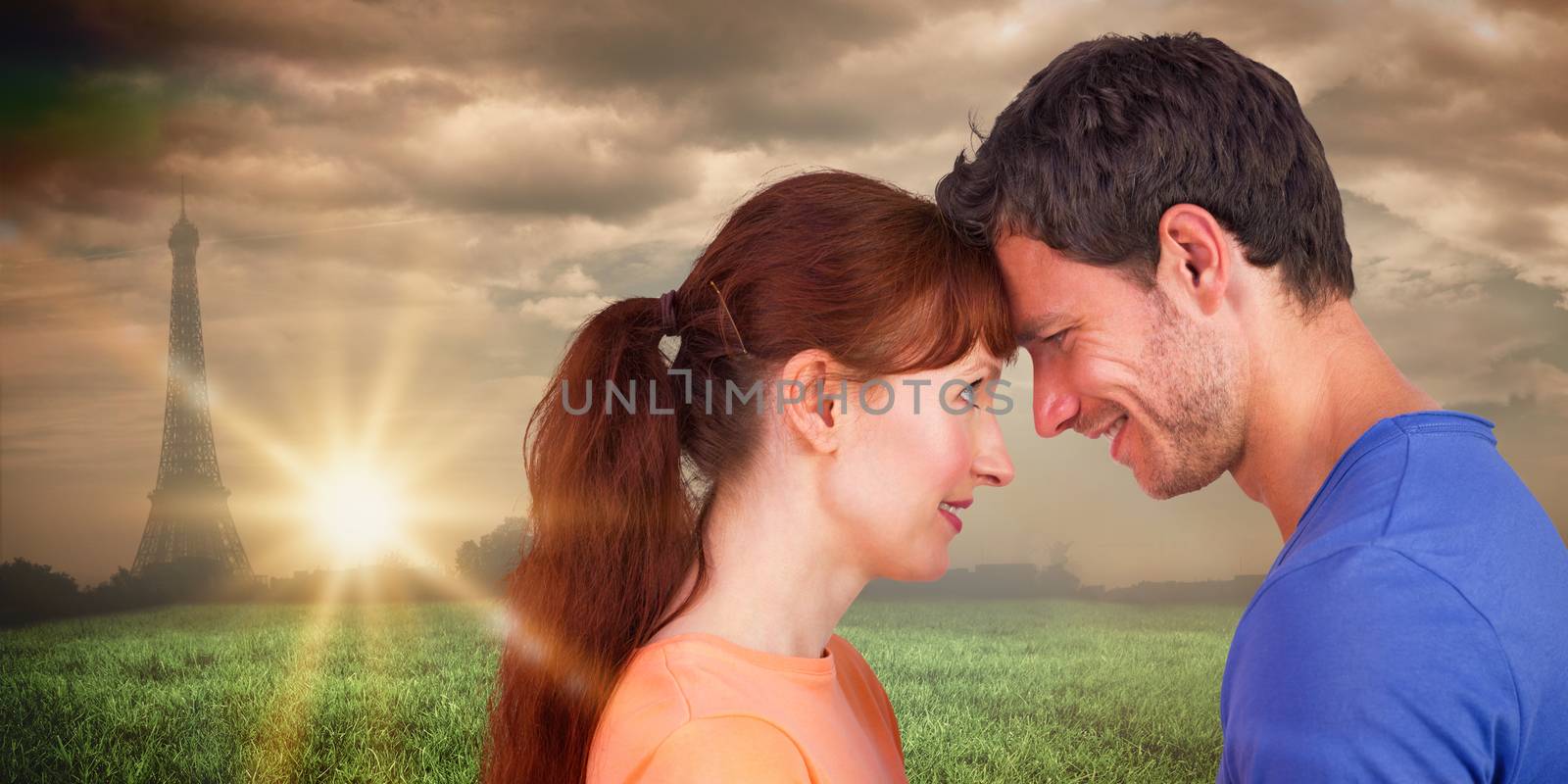 Couple looking at each other against paris under cloudy sky