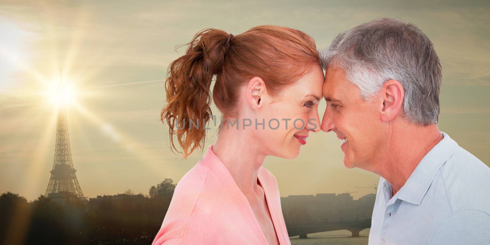 Casual couple smiling at each other against eiffel tower
