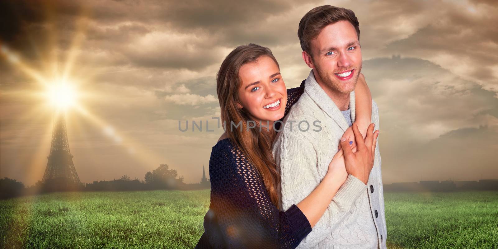 Portrait of happy young couple against paris under cloudy sky