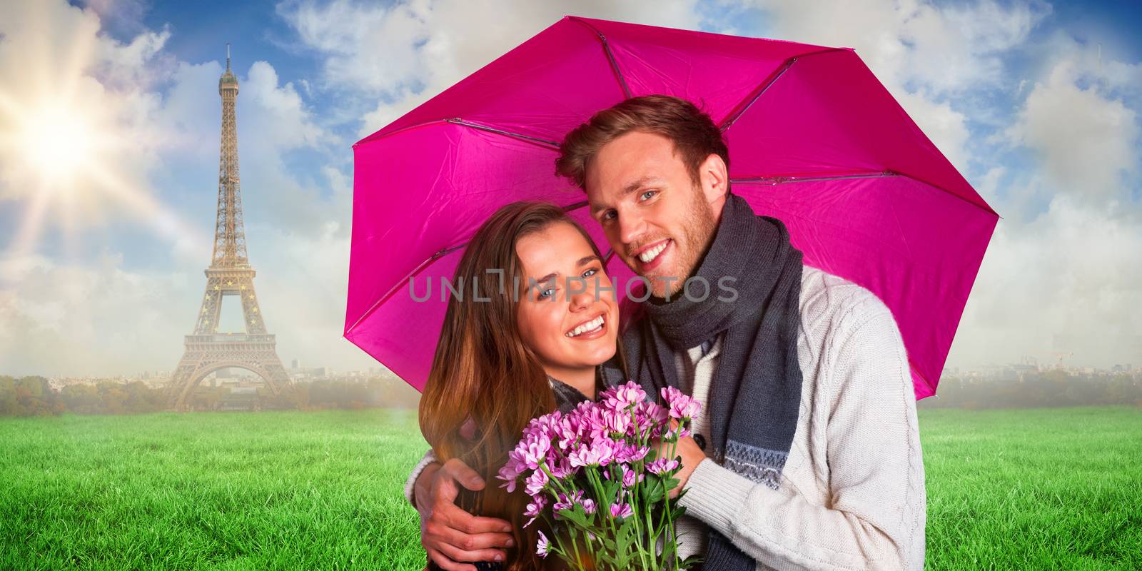 Cheerful young couple with flowers and umbrella against eiffel tower