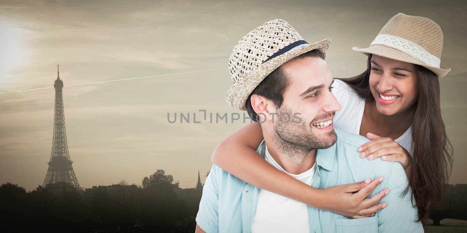 Happy casual man giving pretty girlfriend piggy back against eiffel tower